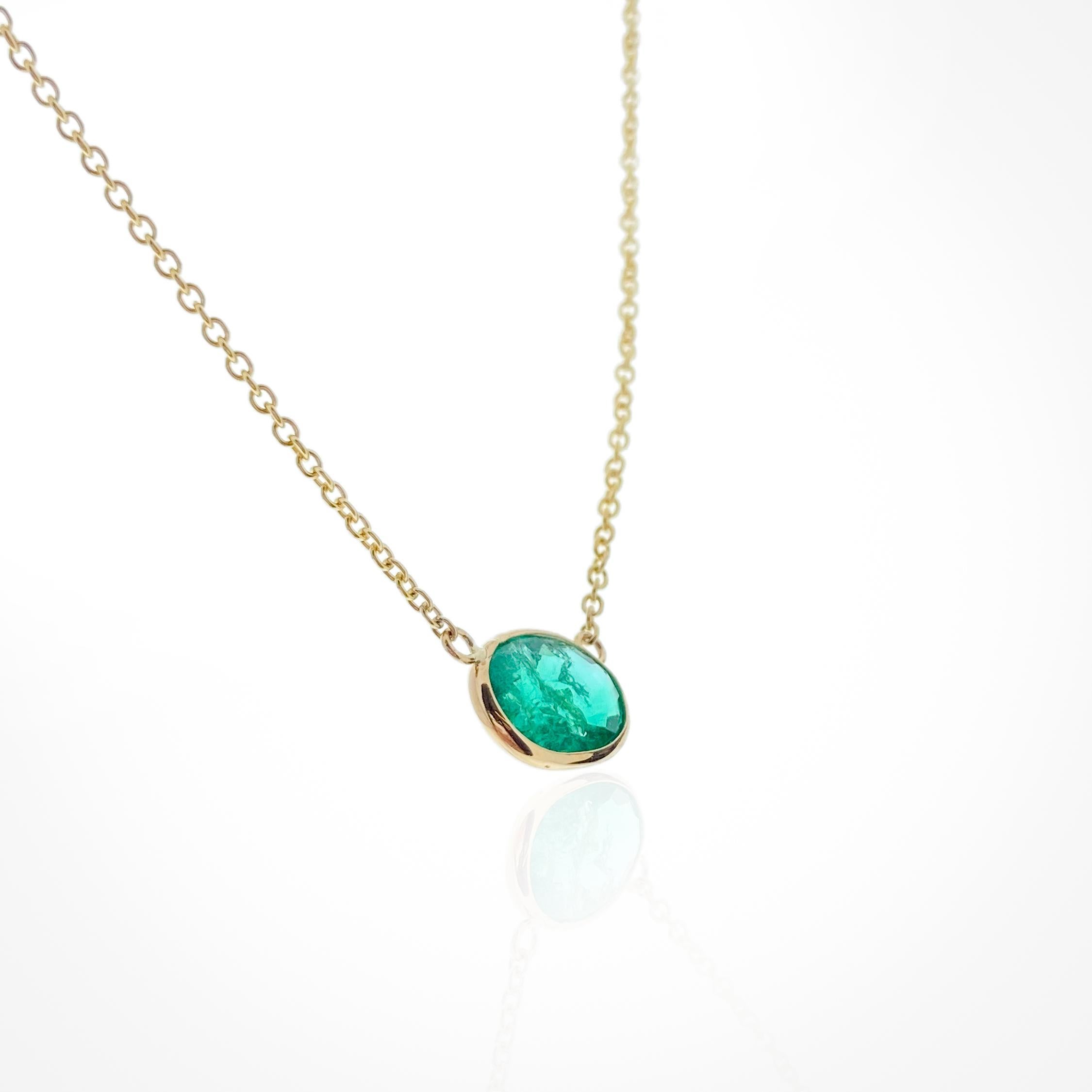 This necklace features an oval-cut green emerald with a weight of 1.61 carats, set in 14k yellow gold (YG). Emeralds are known for their stunning green color, and the oval cut is a classic and elegant choice for gemstones. Necklaces with emeralds