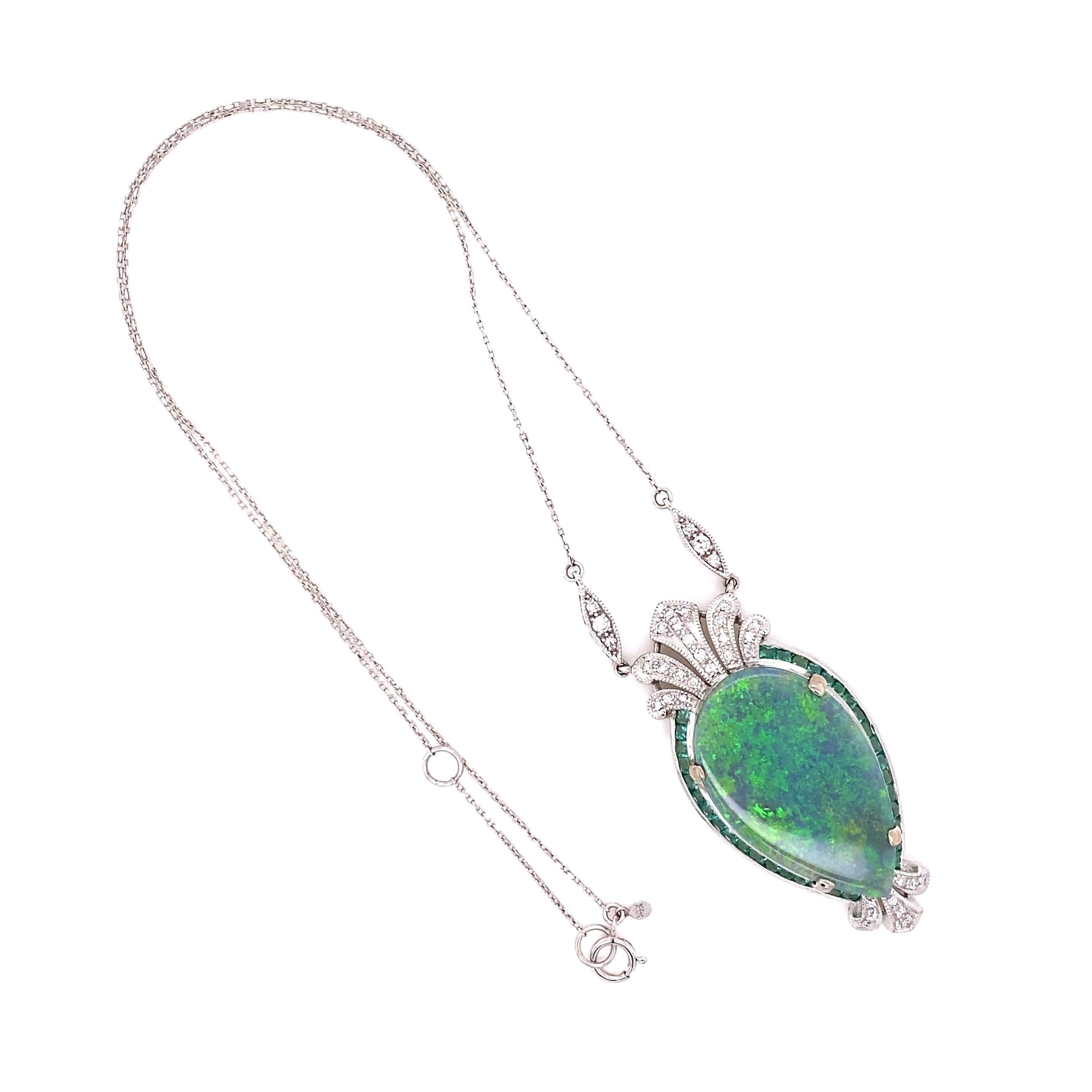 Simply Beautiful! Elegant and finely detailed House of Ming design with a Natural Australian Lightning Ridge Dark Gray Opal Pendant Necklace. Center Hand set with a securely nestled 16.15 Carat Dark Gray Opal surrounded by Emeralds weighing approx.