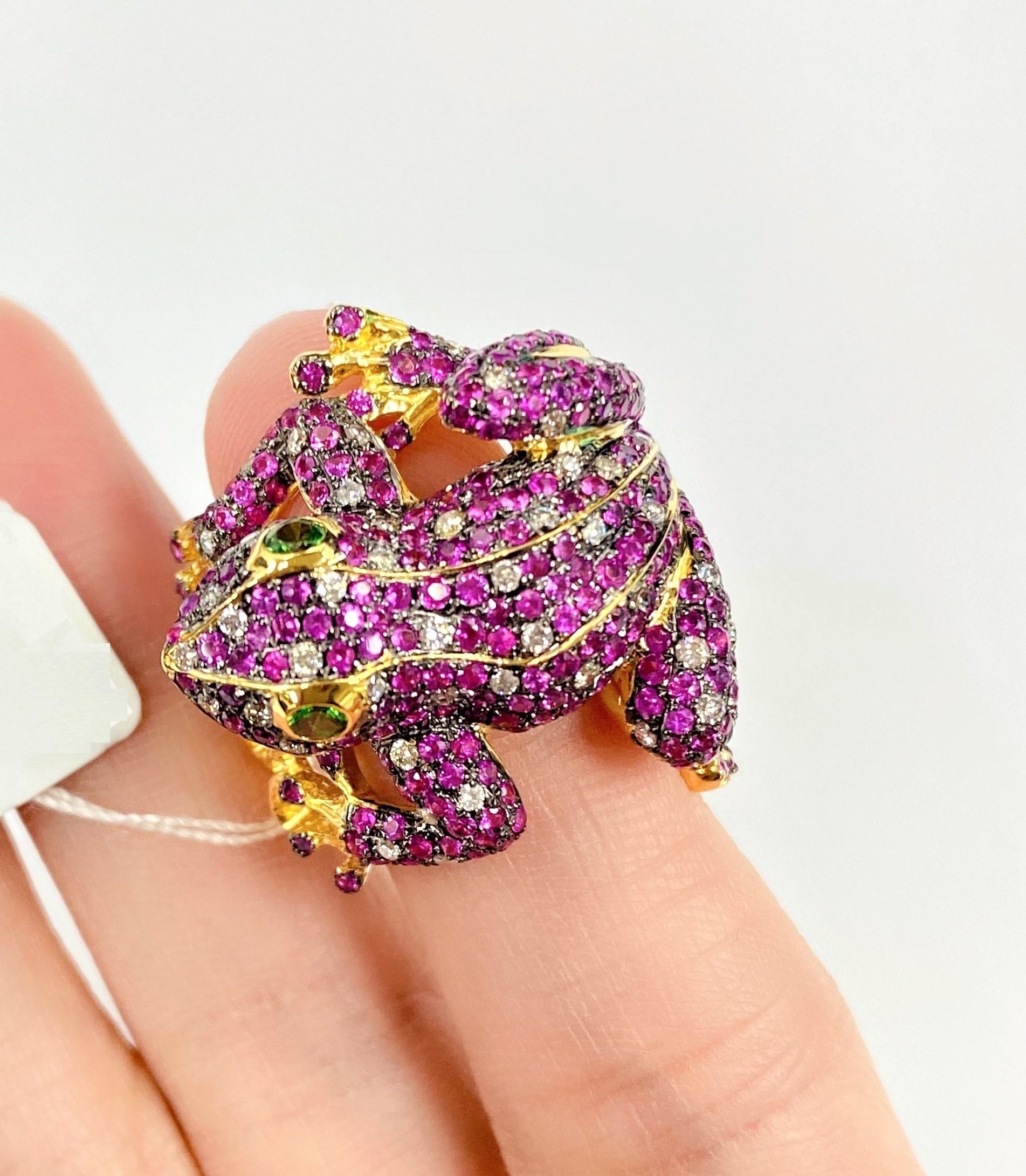 The Following Items we are offering is An Outstanding 18 Karat Gold Red Sapphire, Tsavorite, and Diamond Ring, consisting of an 18KT Golden Jeweled frog pave set with numerous round single cut, Red Sapphires, Diamonds and two round mixed cut
