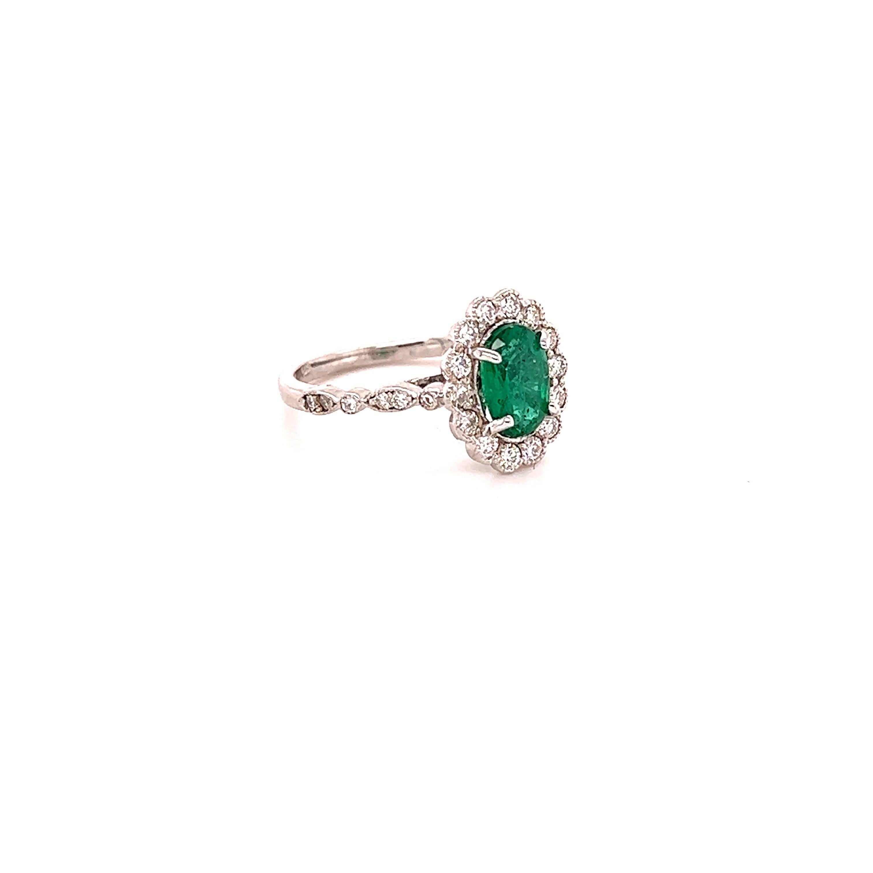 This ring has a 1.09 Carat Oval Cut Emerald and is surrounded by 28 Round Cut Diamonds that weighs 0.53 Carats. (Clarity: SI1, Color: F) The total carat weight of the ring is 1.62 carats. 
The Oval Cut Emerald measures at approximately 8 mm x 6 mm.