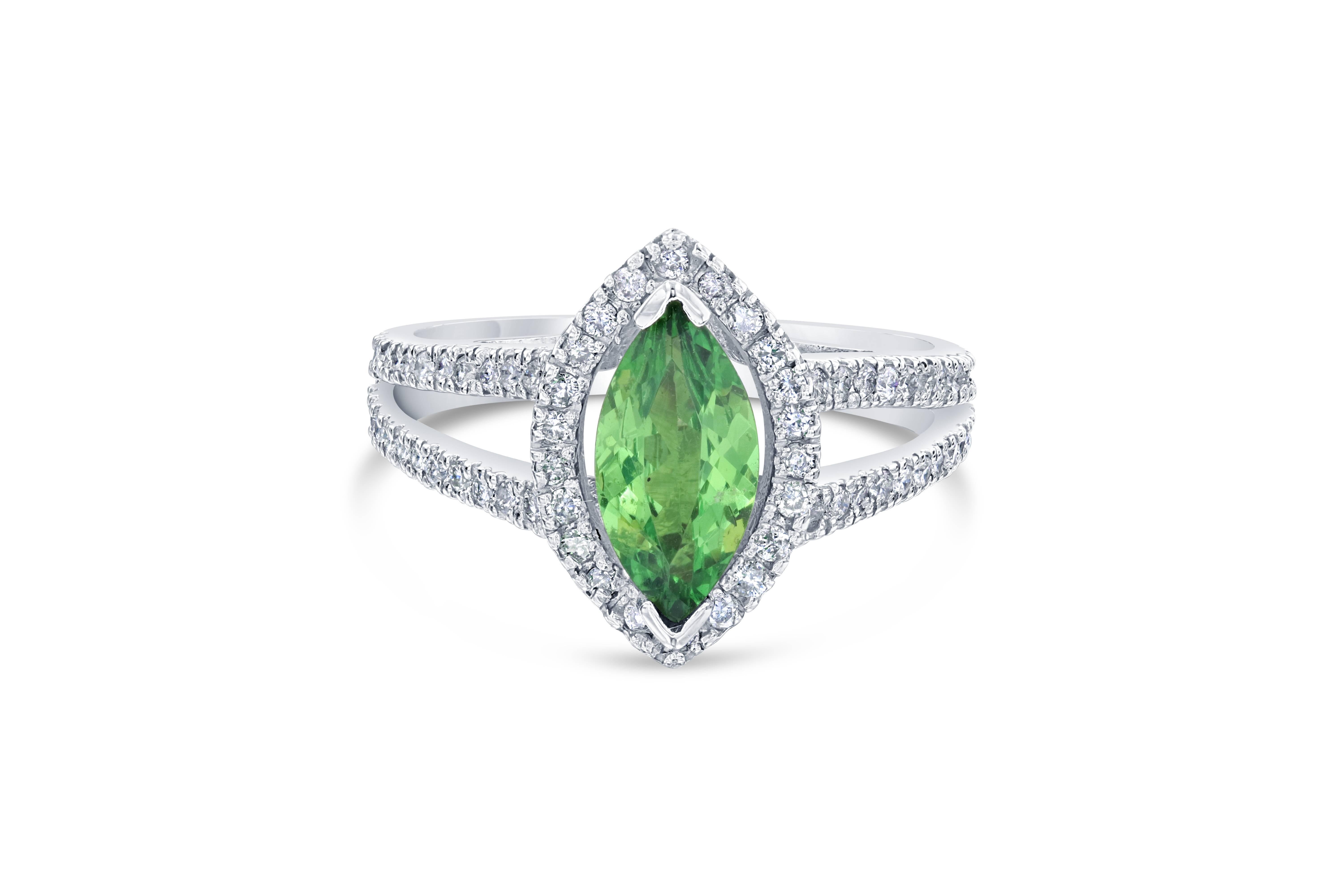 A gorgeous setting with a stunning center gem that can easily be a cocktail ring or a unique engagement ring, The ring has a Marquise Cut Tsavorite which weighs 1.10 carats and is surrounded by 70 Round Cut Diamonds that weighs 0.52 carats. The