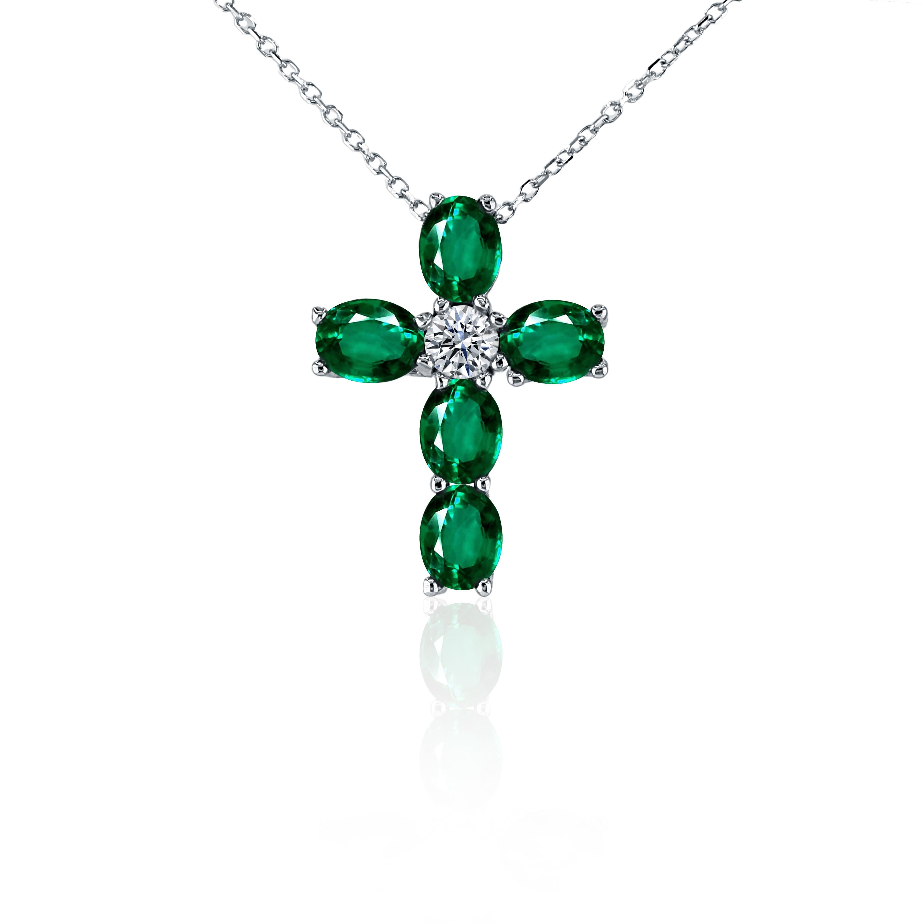 The epitome of grace and spirituality, this cross pendant is a testament to timeless beauty and divine elegance!

Five mesmerizing oval cut emeralds, totaling 1.62 carats, delicately encircle a central, radiant round natural diamond (0.19 carats),