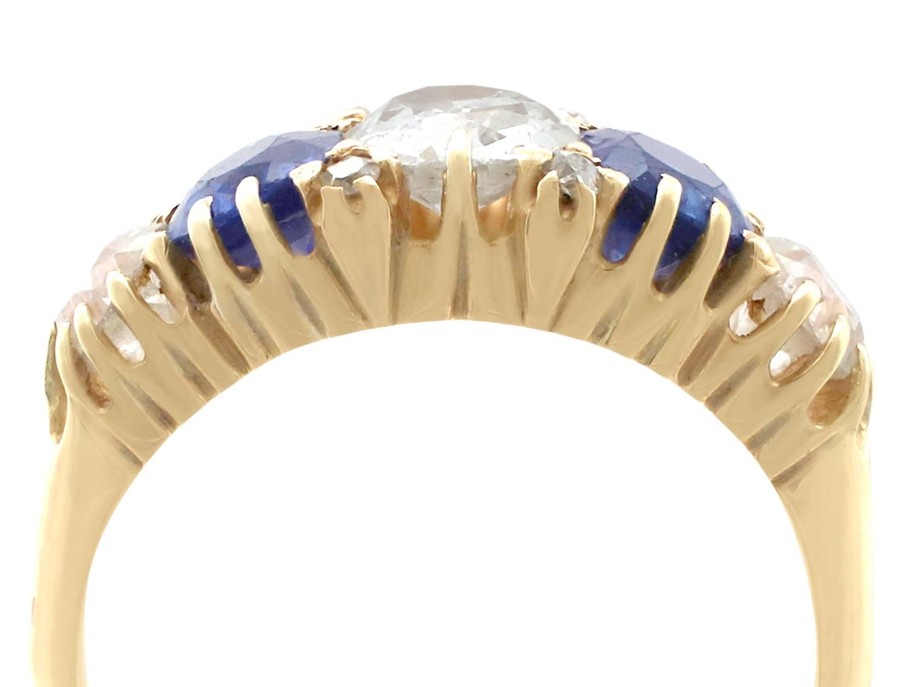 A stunning, fine and impressive antique 1.62 carat natural blue sapphire and 1.45 carat diamond, 18 karat yellow gold, five stone ring; part of our antique jewellery and estate jewelry collections.

This stunning, fine and impressive antique