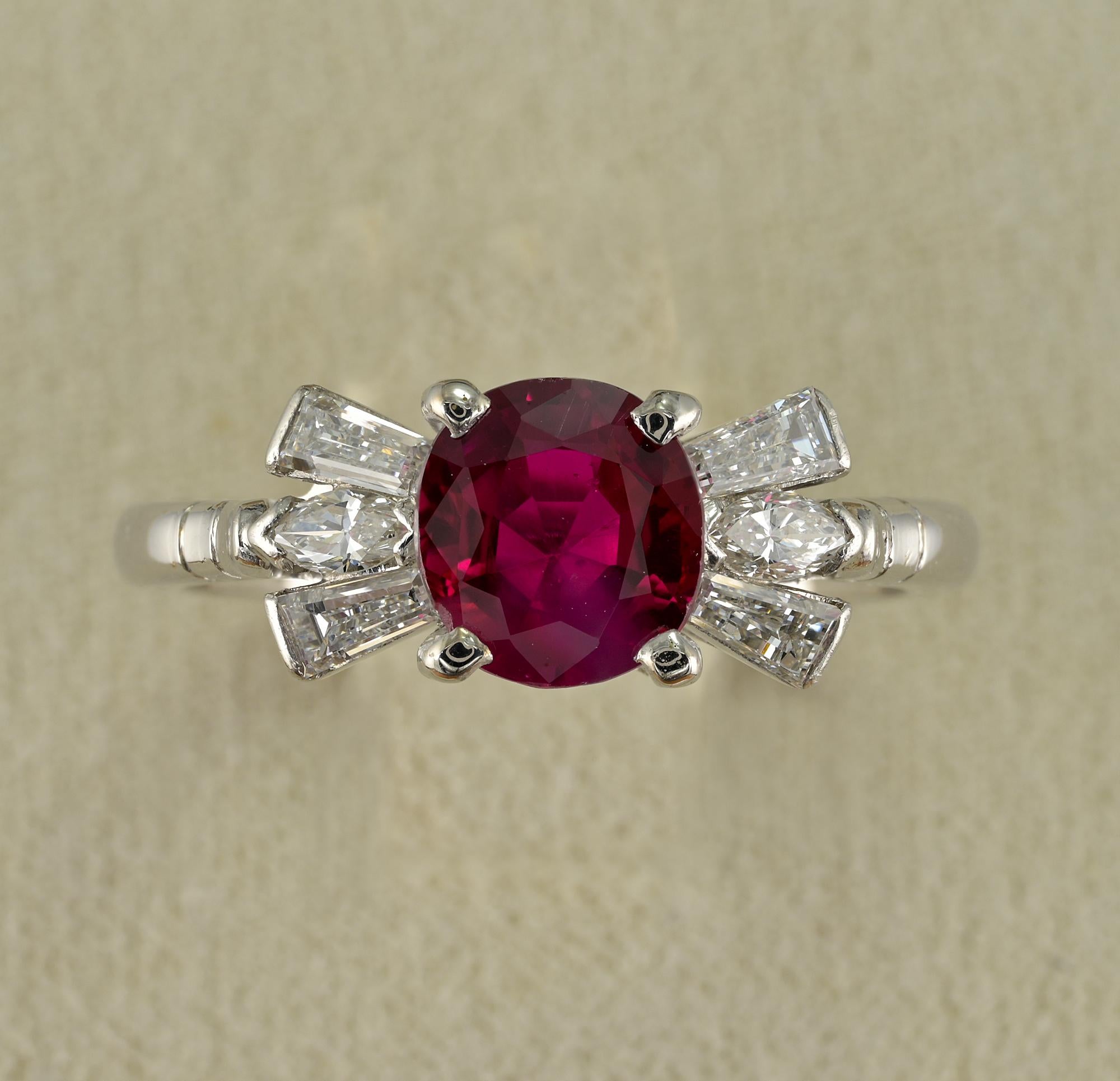 Marvelous mid century Diamond Ruby ring, 1960 ca.
Hand crafted mount of solid 18 KT gold Platinum topped
Elegant timeless design with center Ruby flanked by group of Diamonds between tapered baguette and marquee shaped cut
Focal point is a