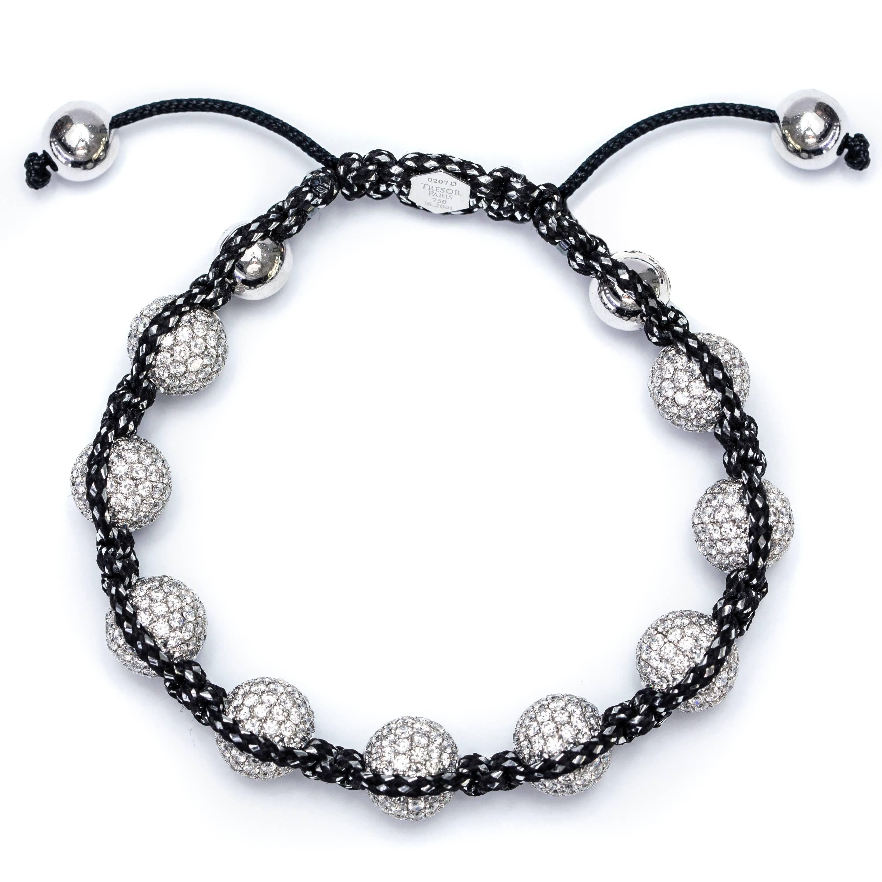 This stunning and bespoke 16.20 Carat Pave set Round Brilliant H-SI Diamond Ball bracelet from the Tresor Original Collection strung on Black and Silver Cord featuring a Silver Tresor Paris Logo. This classic bracelet made to the finest Artisan