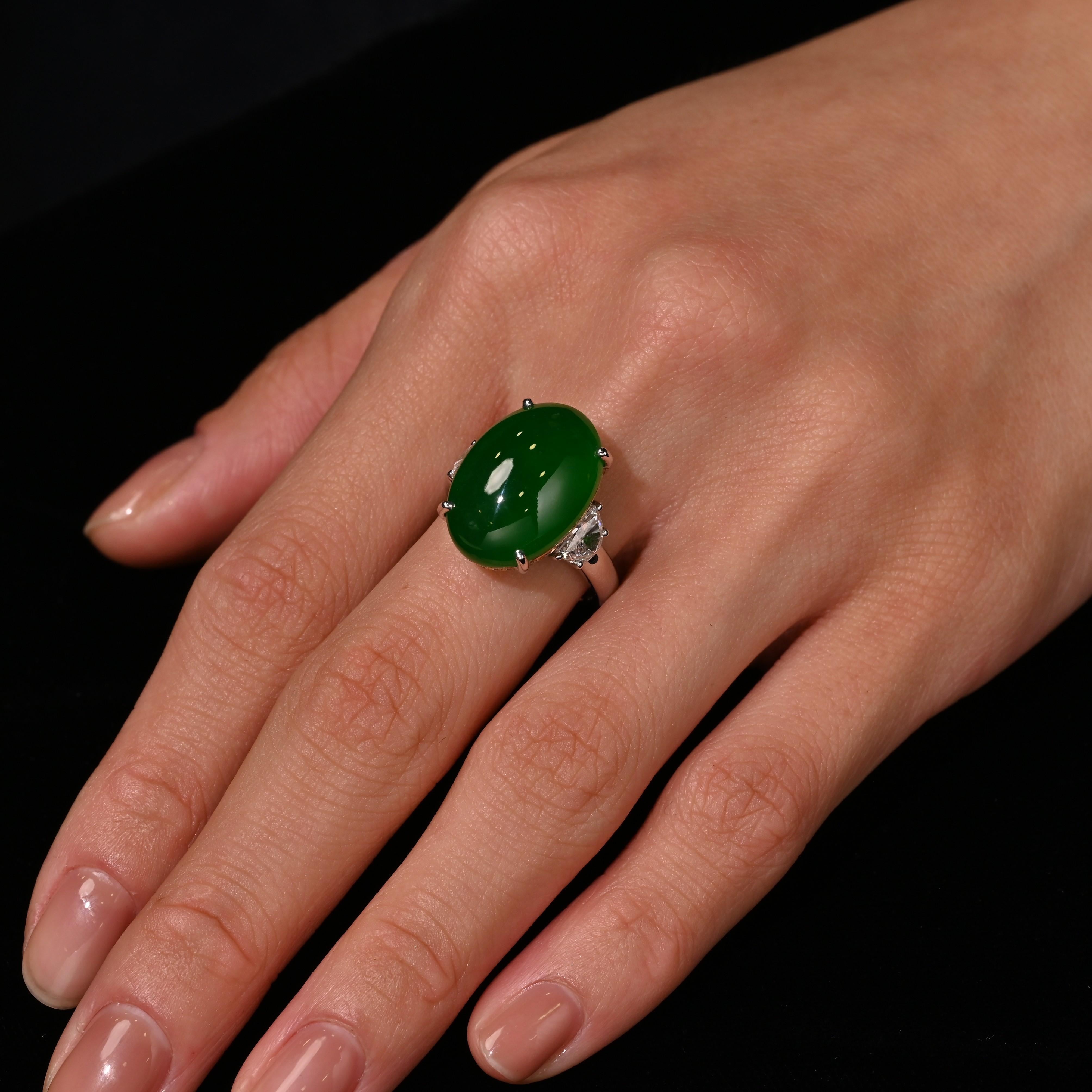 Certified 16.25 carat Imperial Jade ring in 18K white gold with 0.82 carat trapezoid diamonds and a round cut diamond hidden halo featuring prong-set center stone and diamond accents. Sophisticated three-stone design with bold jade centerpiece, size