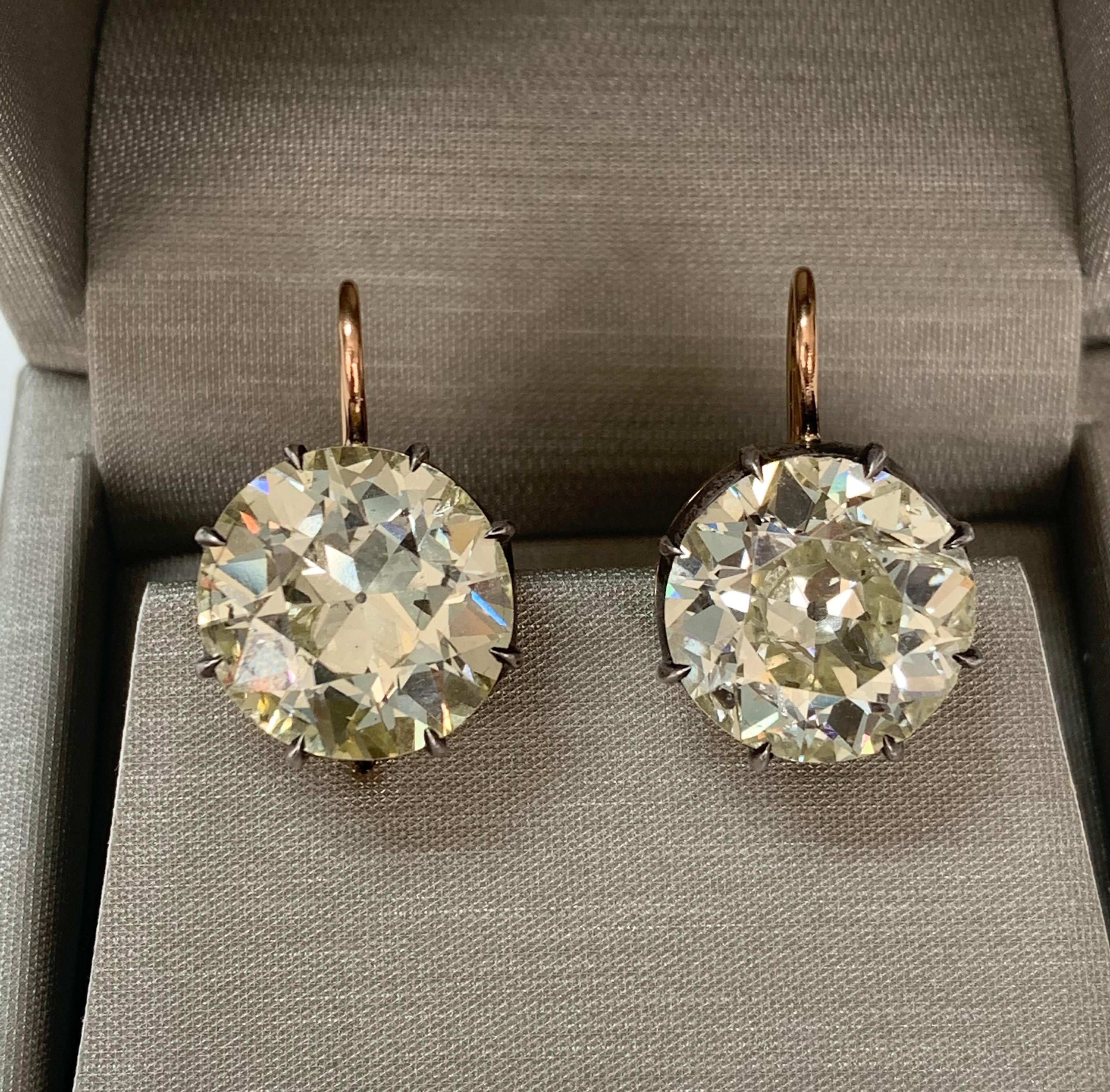 The true essence of understated elegance. These antique style rose gold and silver collet wire drop earrings are handcrafted and set with two old European diamonds ( warm color and SI clarity ). 
The details are as follows : 
Old European cut