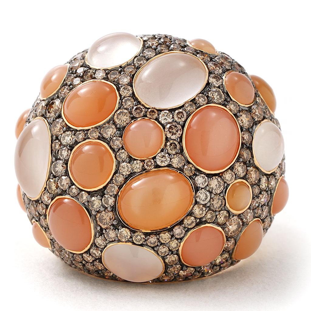 This stunning cocktail ring is made of 18K rose gold and weighs 12.2 DWT (approx. 19 grams). It contains 22 cabochon cut Cat's Eye Moonstones weighing a total of 12.52 carats. These unique gemstones are adorned by 251 pave set round brown diamonds