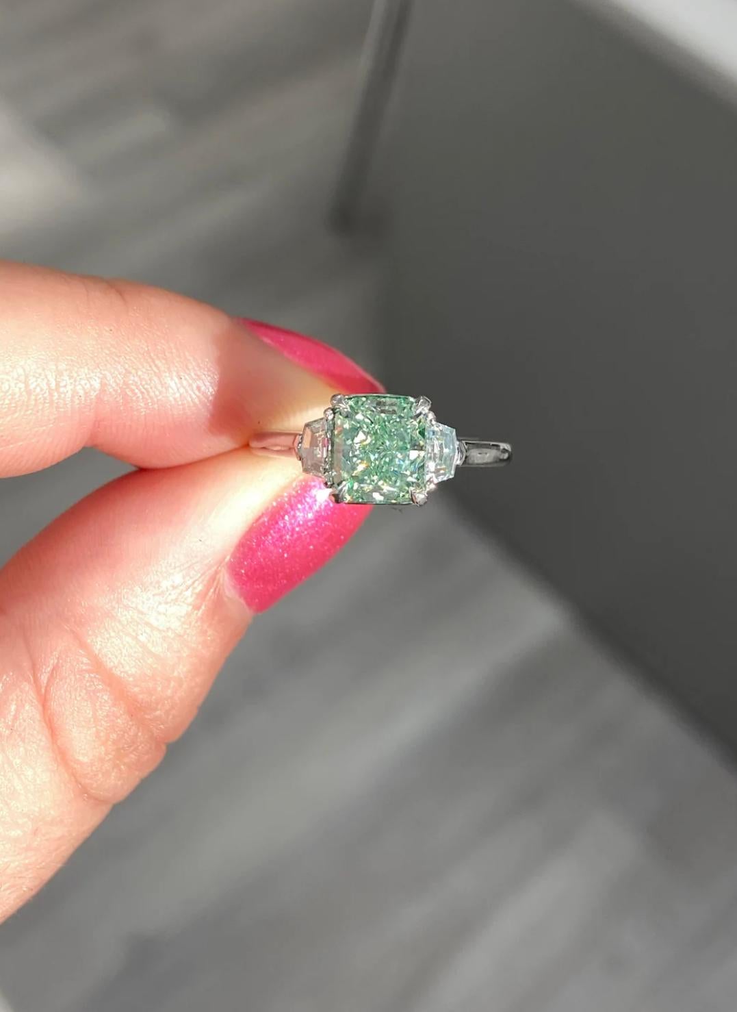 1.62ct Fancy Intense Yellowish Green with lime green color
Radiant cut with great spread
VS2 Clarity
Set in handmade platinum ring with 2 step cut trapezoid diamonds