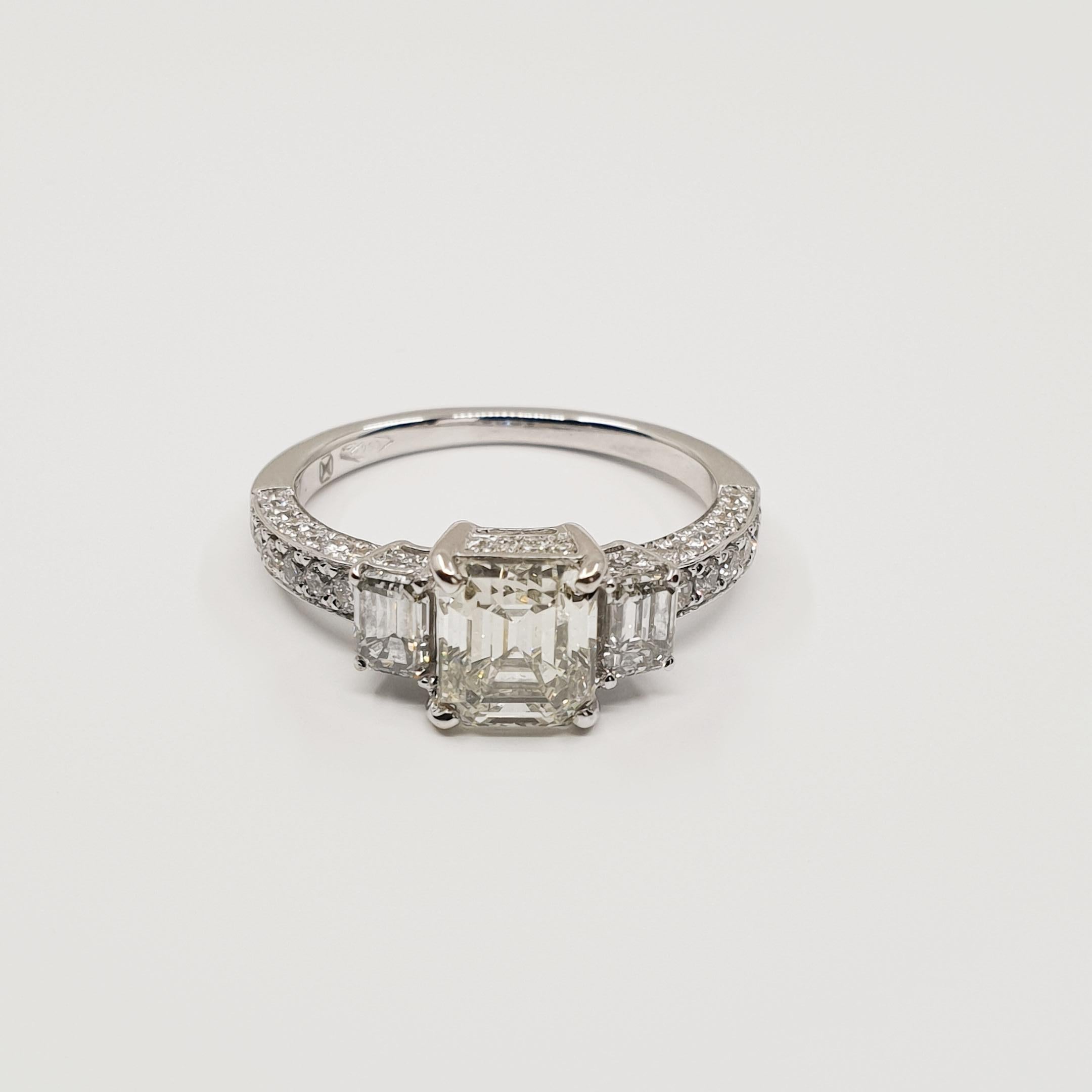 1.63 Carat Asscher Diamond Ring I/VVS 18k Gold, Baguette and Brilliant Sides

Exceptional 1.63 Carat Asscher Cut Diamond Ring with two Baguette side stones total 0.55 Carat and 
0.57 Brilliant Cut Pave Diamonds. 
Stunning Piece of High Jewelry whith