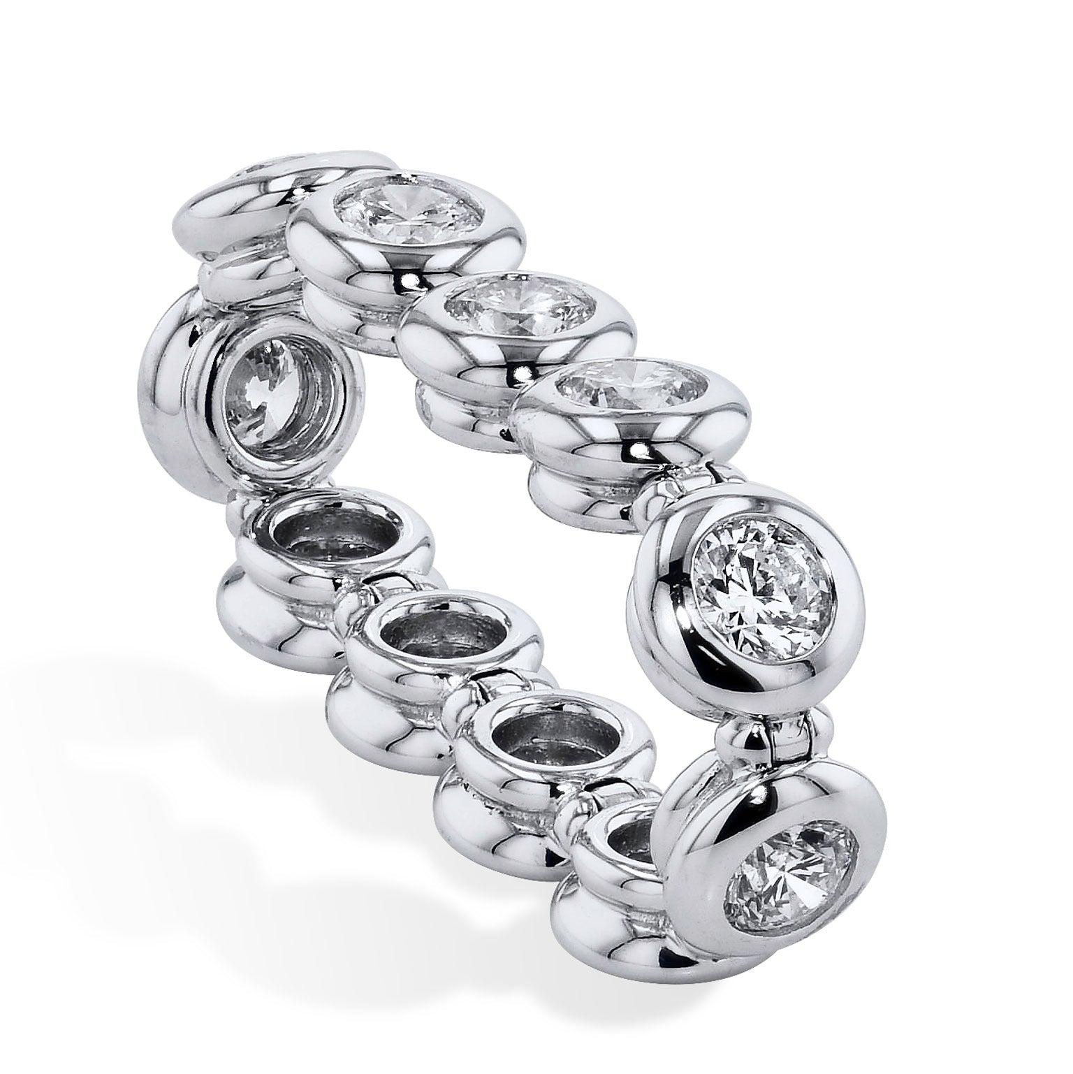 This handcrafted 18 karat white gold eternity flexi-band ring features eleven diamonds bezel-set and placed together to produce 1.63 carat (F/G/VS2) of brilliance. This band ring stirs and illuminates the essence of her beauty.

