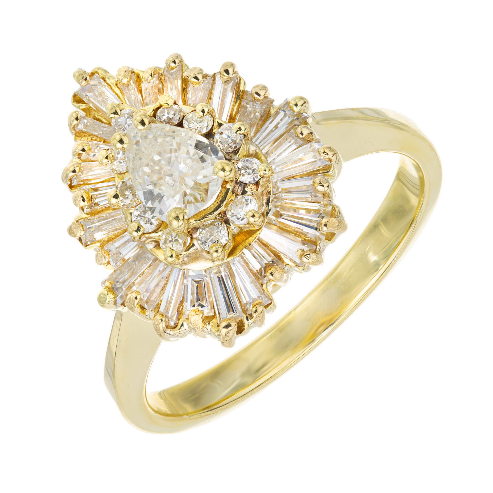 1980's classic diamond Ballerina style engagement ring. 1 pear shaped .38cts center stone. Mounted in a 18k yellow gold heart shaped setting with two diamond halos, one with 11 round brilliant cut diamonds and the second with 26 baguette shaped