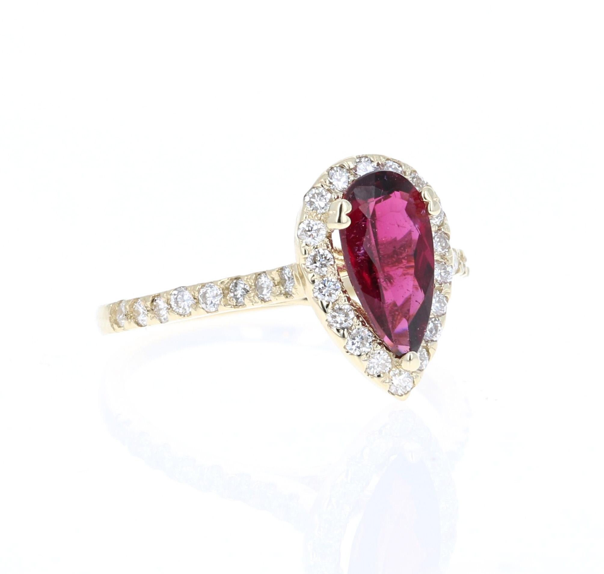 1.63 Carat Tourmaline Diamond 14K Yellow Gold Engagement Ring.
This stunning piece has a beautiful Pear Cut Red Tourmaline set in the center of the ring.  
The Tourmaline is surrounded by a Halo of 24 Round Cut Diamonds that weigh 0.49 carats