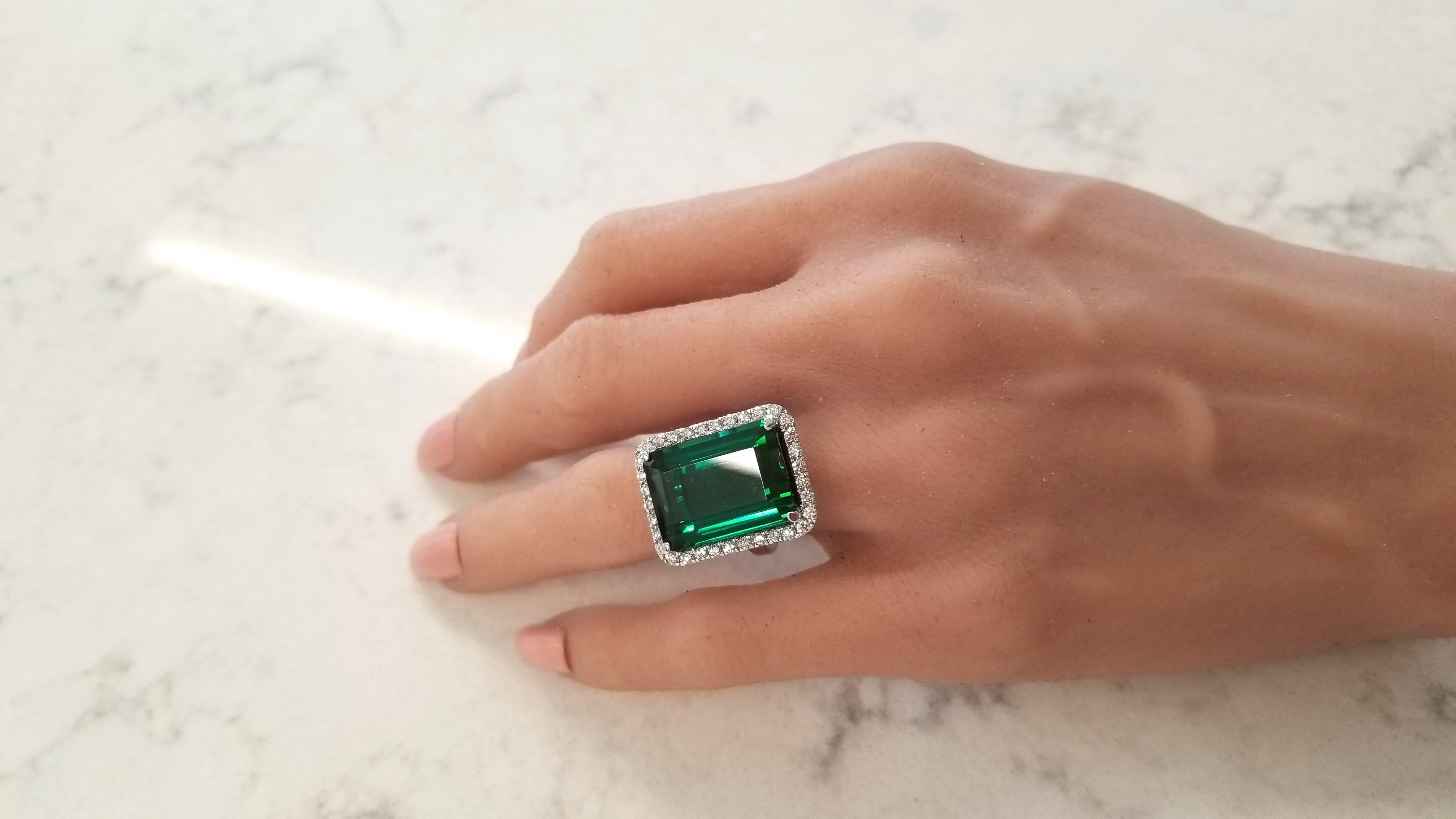This is a 16.30 carat emerald-cut, lush grass green, tourmaline measuring 13 x 9mm. Its gem source is Brazil. This gem's main exhibit is its clean, crisp spring forest green hue. Its transparency and luster are superb. A total of 34 scintillating