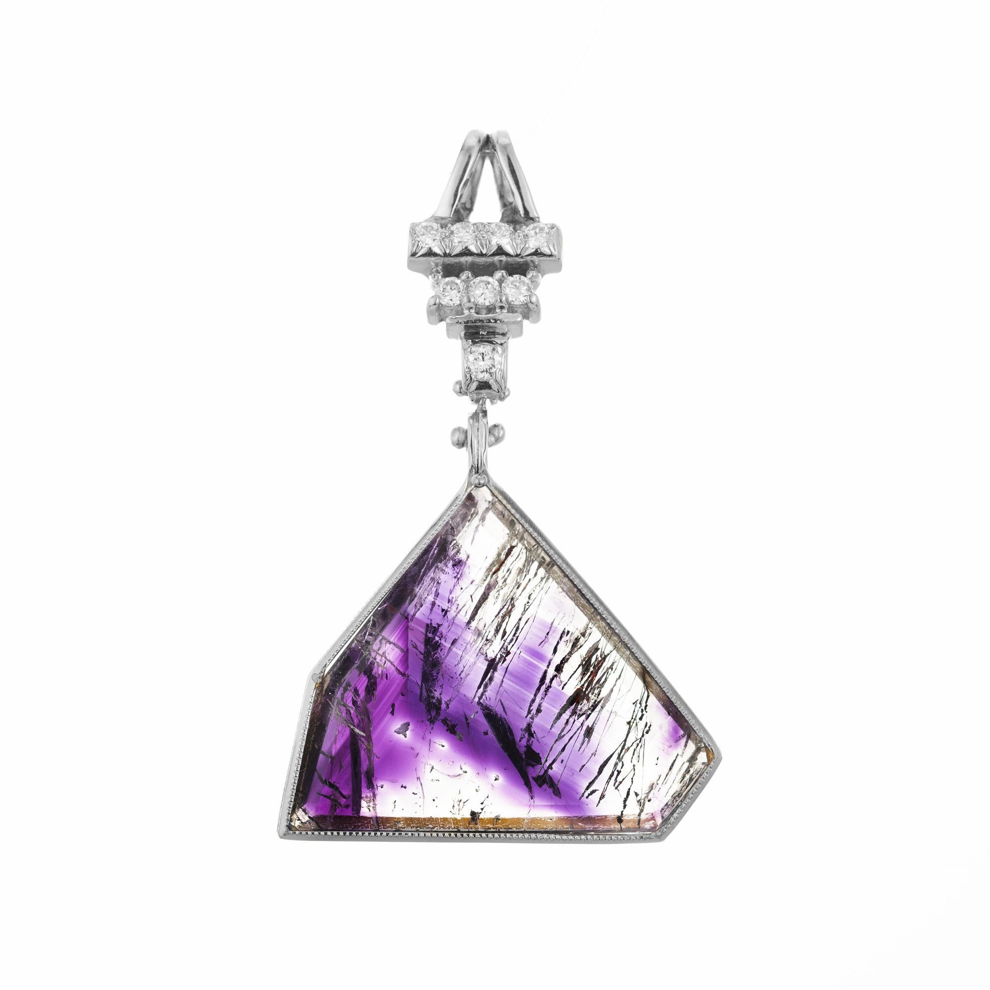 The center piece of the this pendant is the unique and rare 16.31ct Geothite quartz amethyst. Natural and untreated quartz. It has sections of pure clear quartz crystal and distinct areas of bright deep purple quartz, more commonly known as