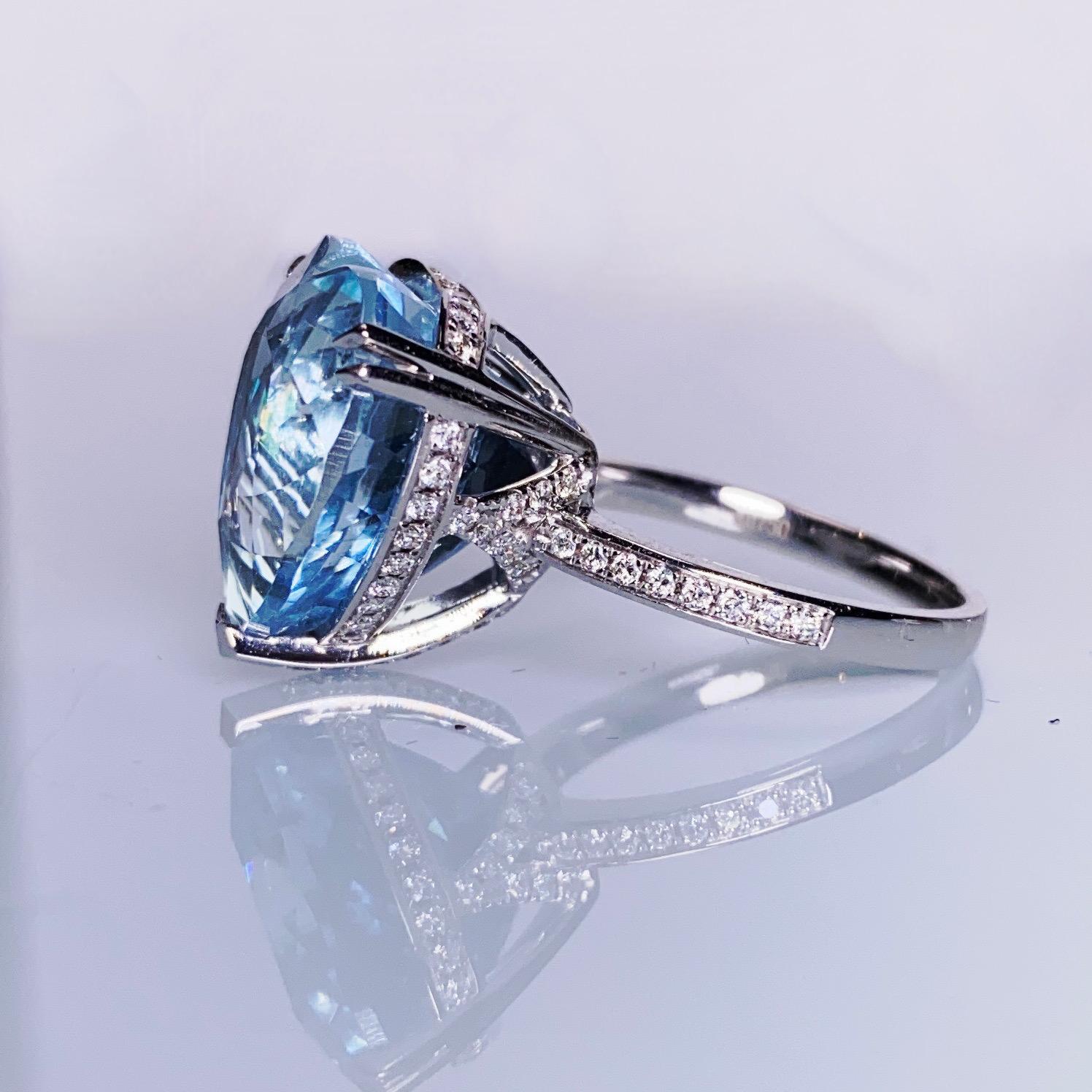 A 16.39 ct Aquamarine and Diamond cocktail Ring in 18k White Gold
It consists of a 16.39 ct transparent Heart shape brilliant cut Aquamarine 
The Aquamarine is in Intense Blue colour, also known as 