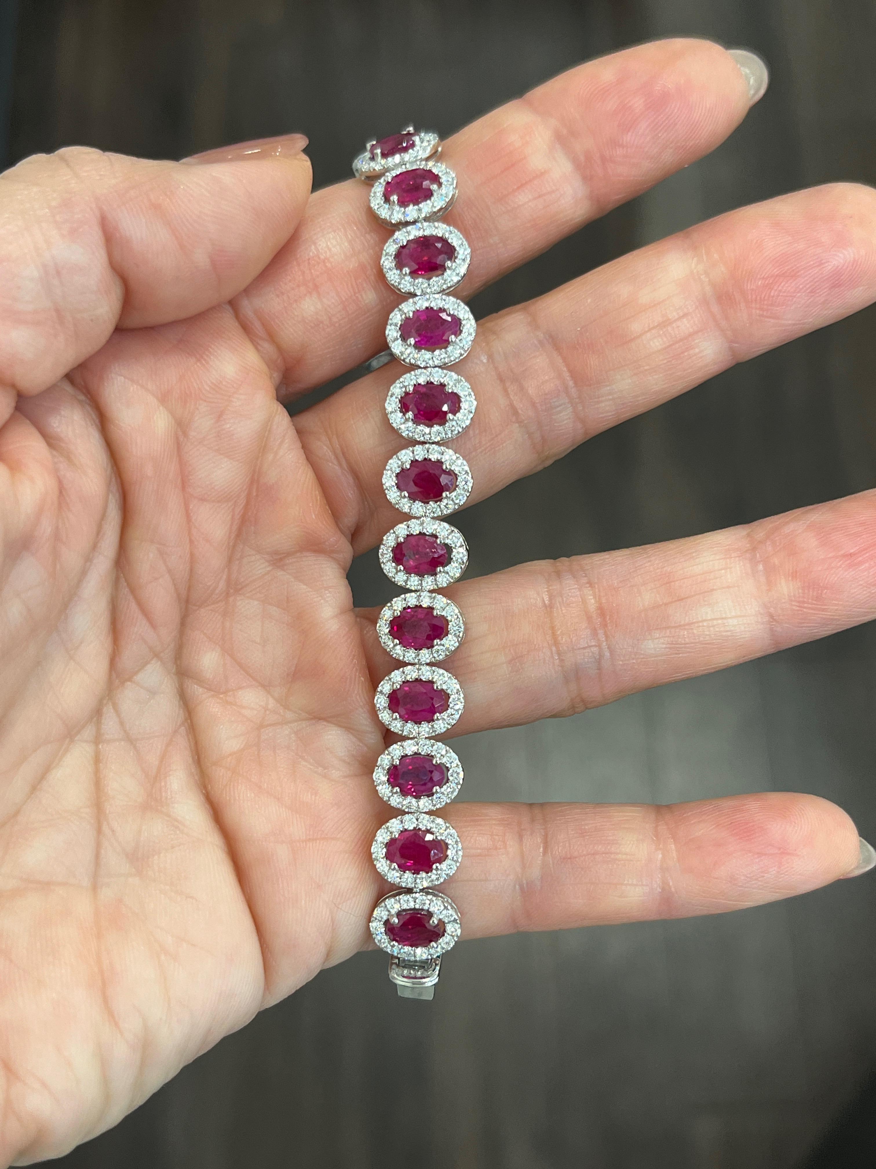 This gorgeous 16.39 ct natural ruby and diamond bracelet boasts 22 natural rubies for 12.02 ct and 308 diamonds for 4.37 ct. The diamonds are E/F in color and VS1/VS2 in clarity. A showstopper to any wardrobe. 