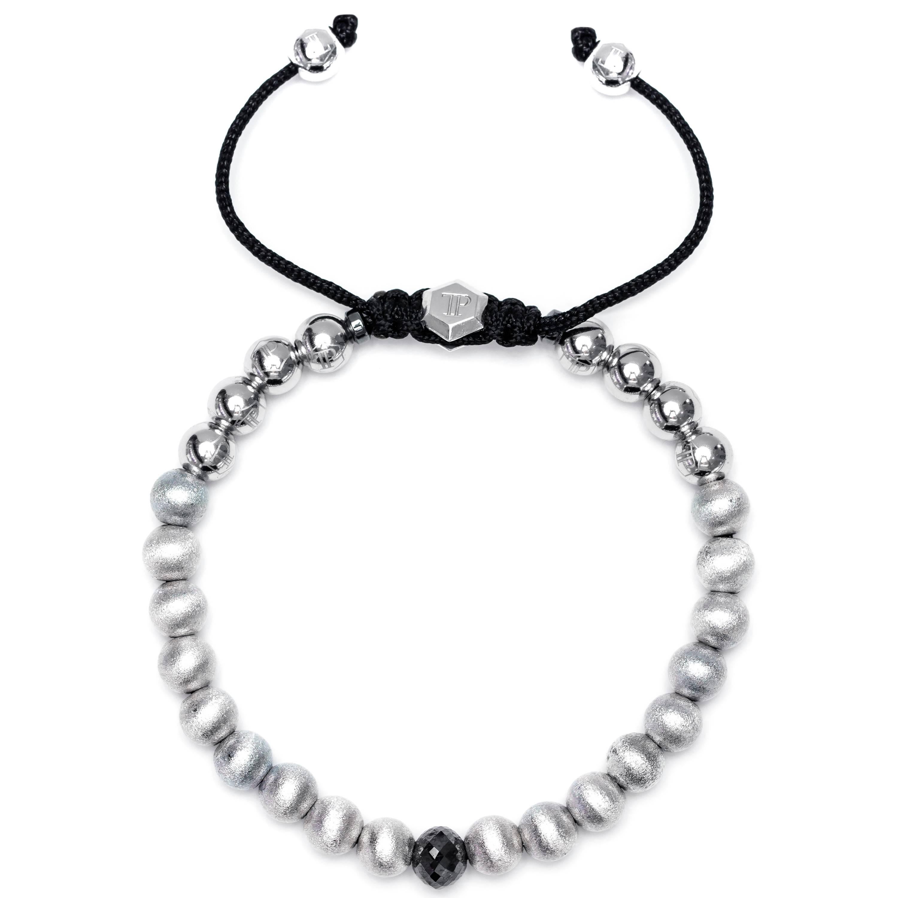 Made to order, this 1.63 Carat Black Diamond Stainless Steel and Silver beaded bracelet features 18 satin beads and 8 Stainless Steel beads and two Magnetite rings with a Silver Hexagon Tresor Paris Logo. Size will fit from 7' to 8' inches (17.78 cm