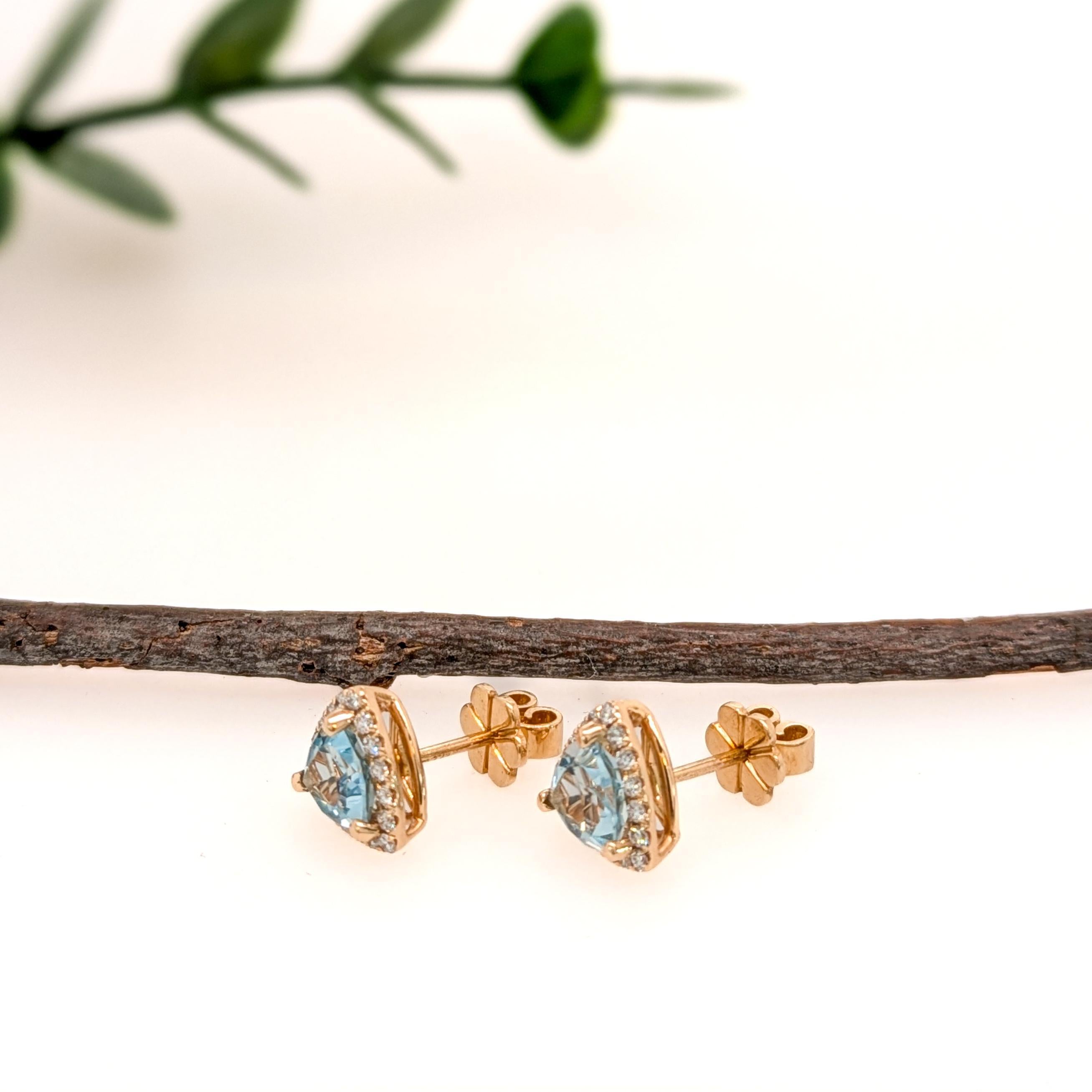 These beautiful stud earrings feature a pair of 1.63 carat weight trillion cut sky blue topaz gemstones with a halo of natural earth mined diamonds, all set in solid 14K gold. These earrings can be a lovely December birthstone gift for your loved