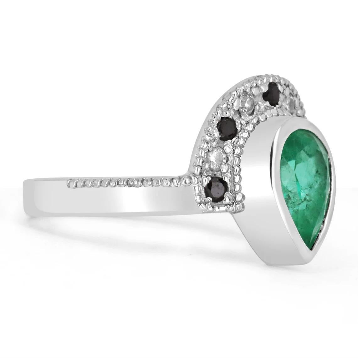 The perfect, tiara emerald & diamond statement ring. This gorgeous piece is sure to get all the right attention! The 1.54-carat pear-shaped emerald is carefully bezel set in a 14K white gold setting. Minor Jardins exist in the emerald as it is