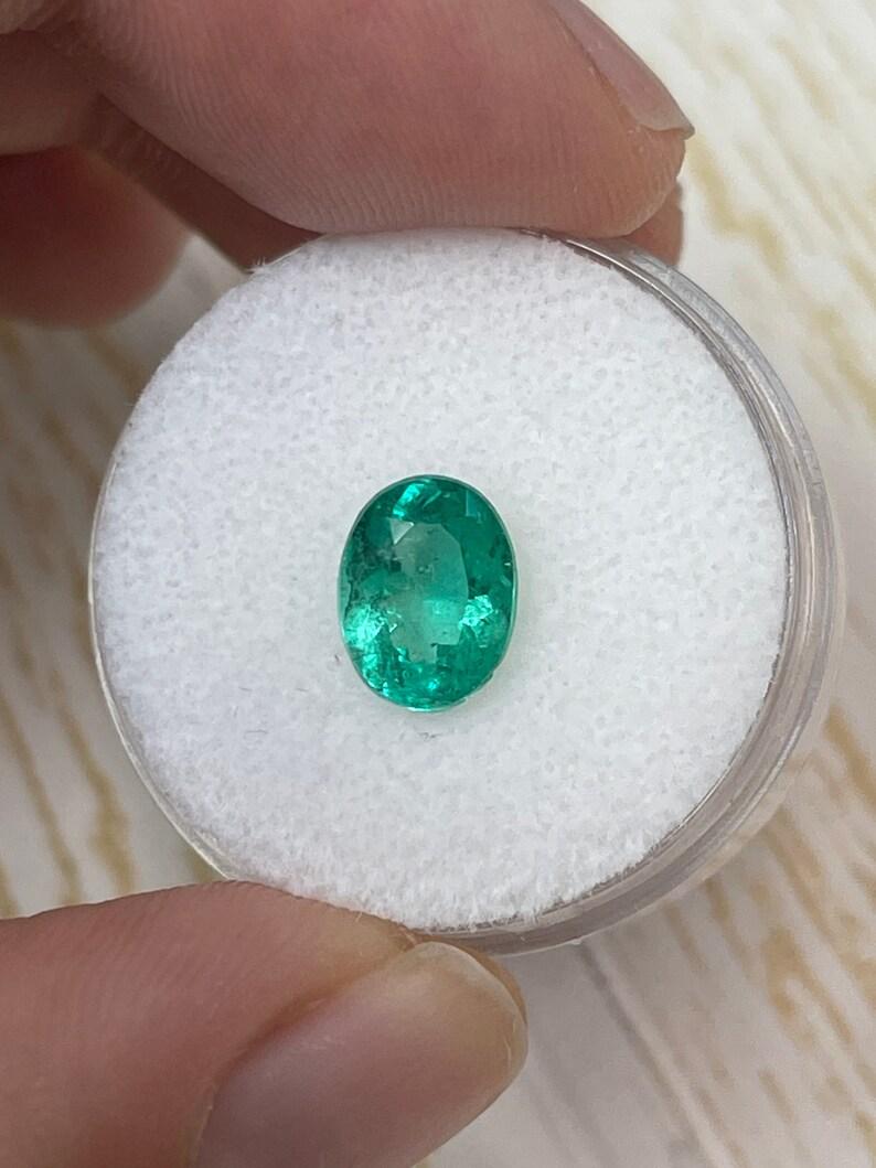 Stone: Emerald
Weight: 1.64-carats
Shape: Oval Cut
Clarity: Transparent
Luster: Very Good
Color: Green
Measurements: 9.09mm x 6.90mm x 4.68mm
Geographic Origin: Colombia
Treatment: Natural, Oiling

This emerald has a chip on its bottom edge which