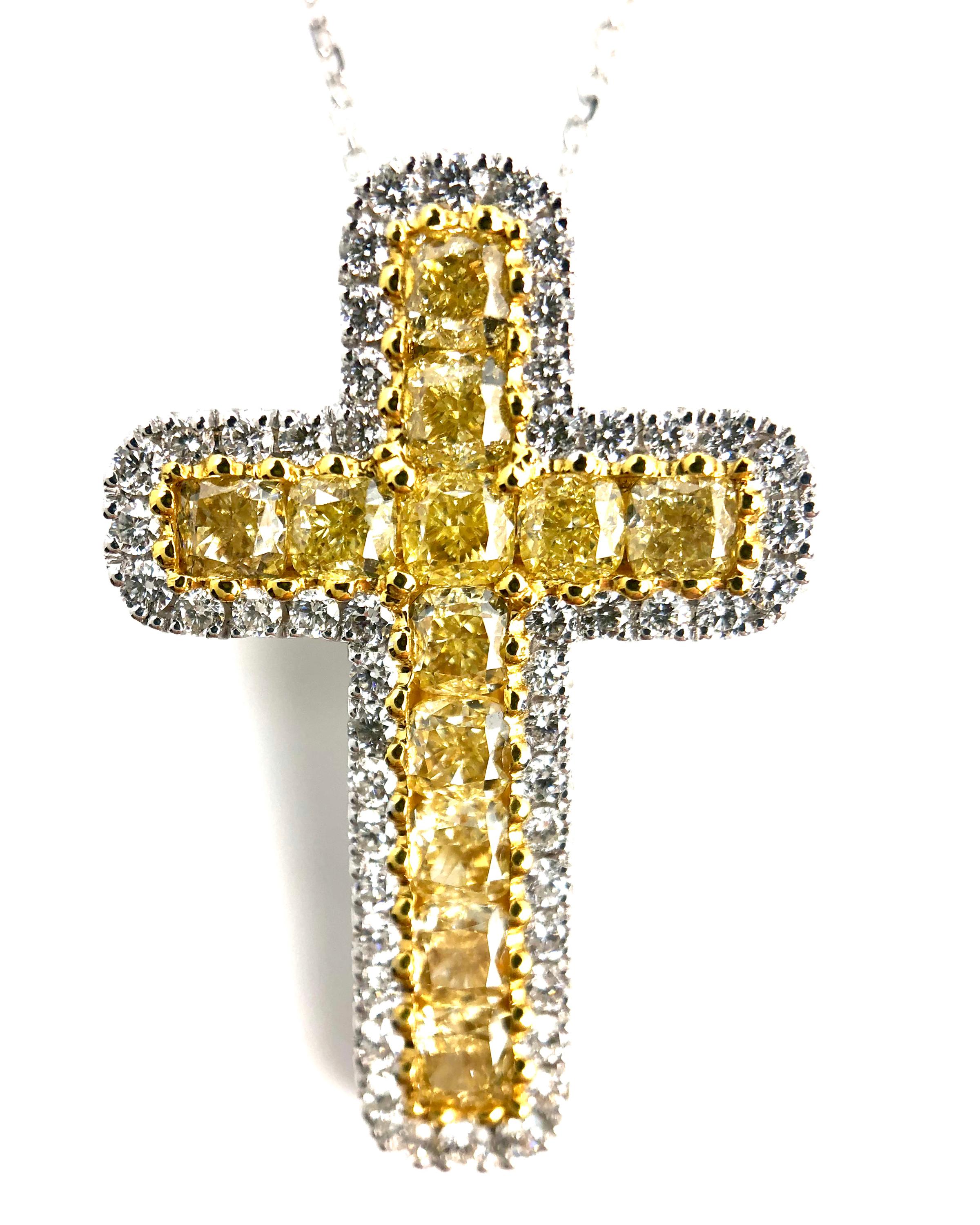 (DiamondTown) This lovely cross pendant features 1.64 carats cushion cut Natural Yellow Diamond, inside a border of round white diamonds.

1.64 carats Natural Yellow Diamond, 12 cushion cut stones
Diamond Halo: 52 round diamonds total 0.41