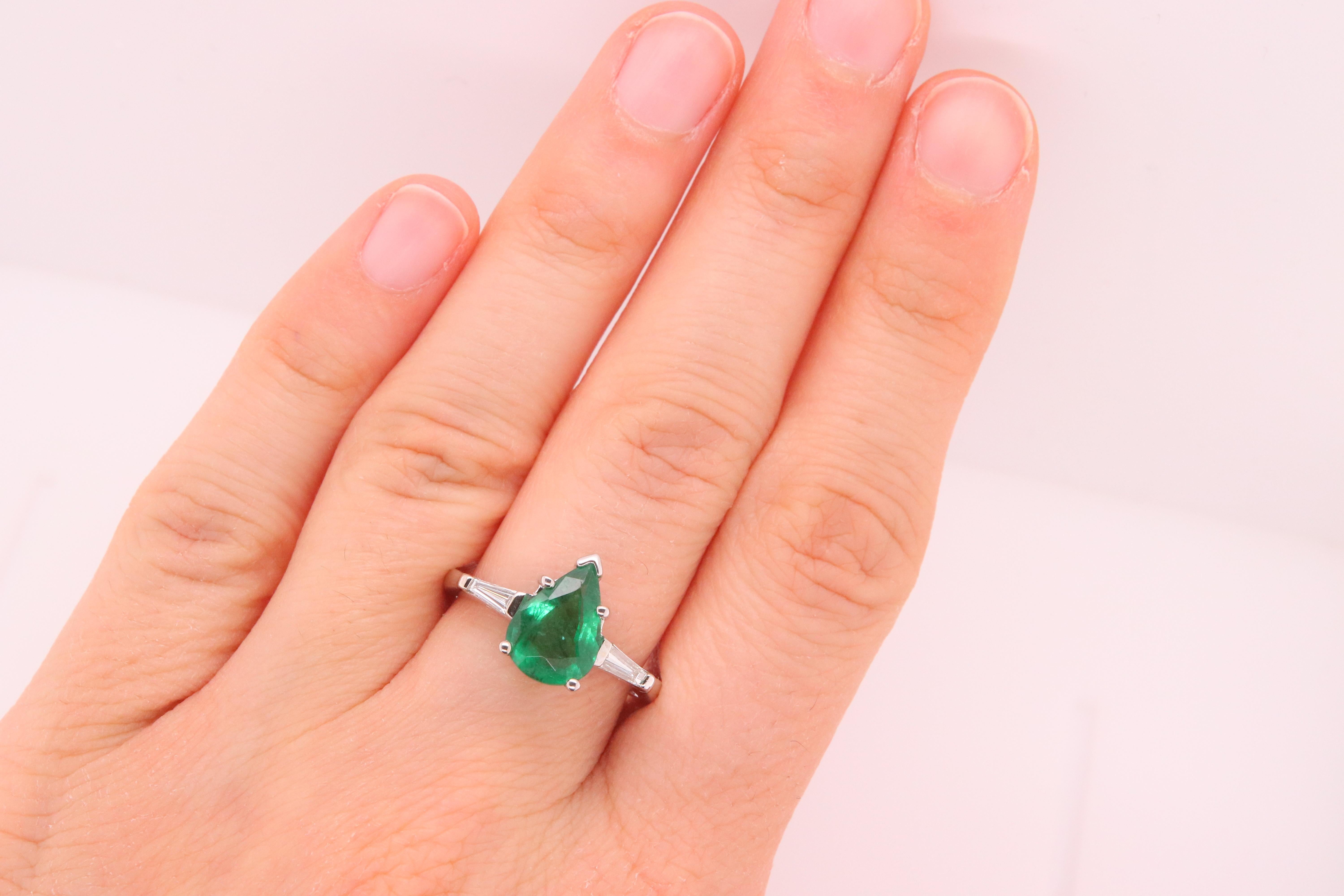 Material: 14k White Gold 
Center Stone Details: 1 Pear Shaped Emerald at 1.64 Carats - Measuring 10.2 x 7.4 mm
Diamond Details: 2 Baguette Diamonds at 0.18 Carats - Clarity: VS-SI / Color: G-H
Ring Size: 6.75. Alberto offers complimentary sizing on