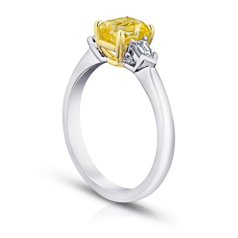 1.64 carat radiant cut (natural no heat) yellow sapphire with straight bullet diamonds .24 carats set in a platinum with 18k yellow gold ring.
