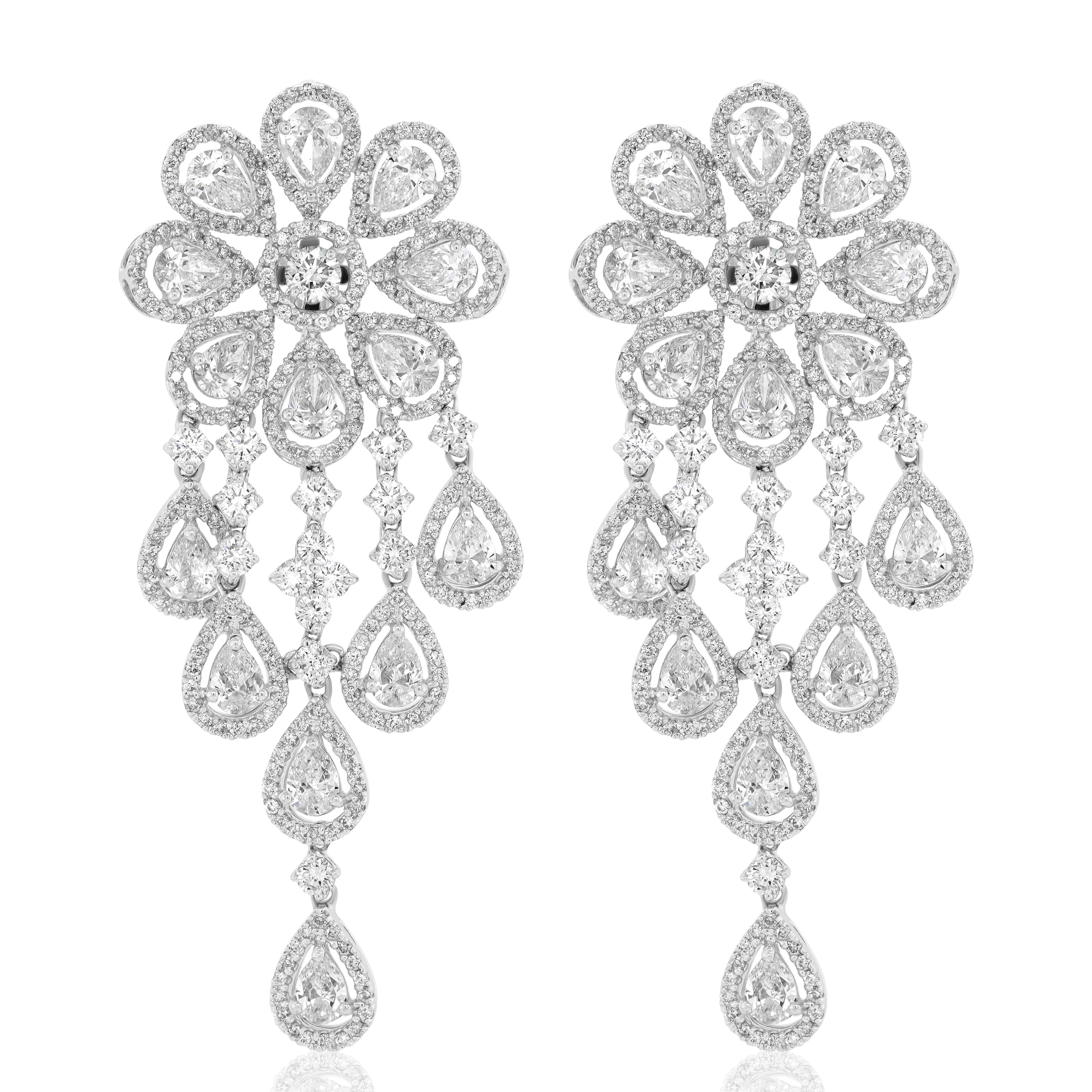 18K White gold diamond cluster earrings features 16.45 carats of diamonds. 
G-H in Color VS - SI in clarity 
(28 PEAR - 9.10CTS; 564 ROUND - 7.35CTS)
