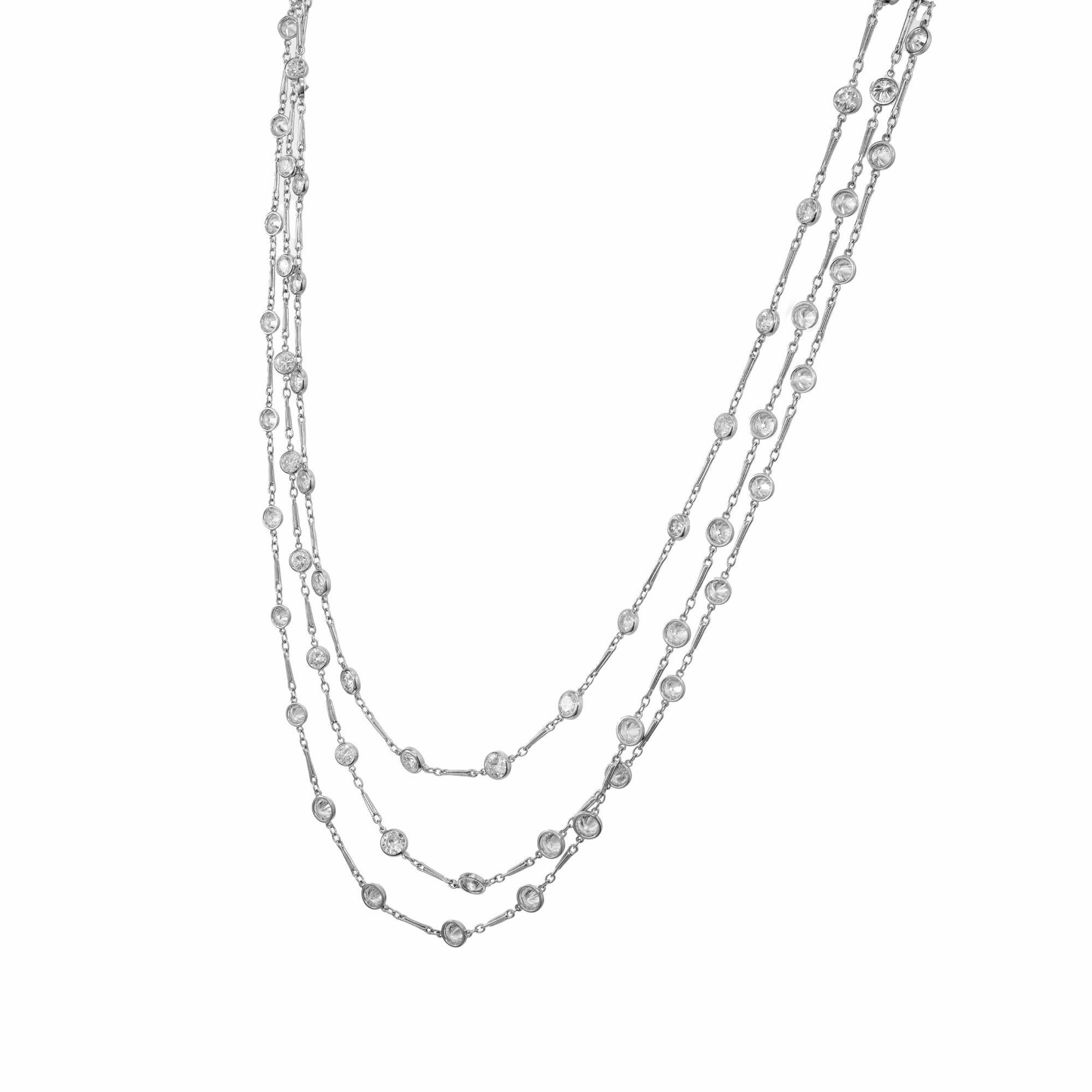 1960's Spectacular diamond bezel set long chain necklace. This stunning necklace is adorned with 78 round brilliant cut bezel set diamonds in a handmade platinum diamond chain. 58 Inches long with a catch and handmade links. The diamonds exude