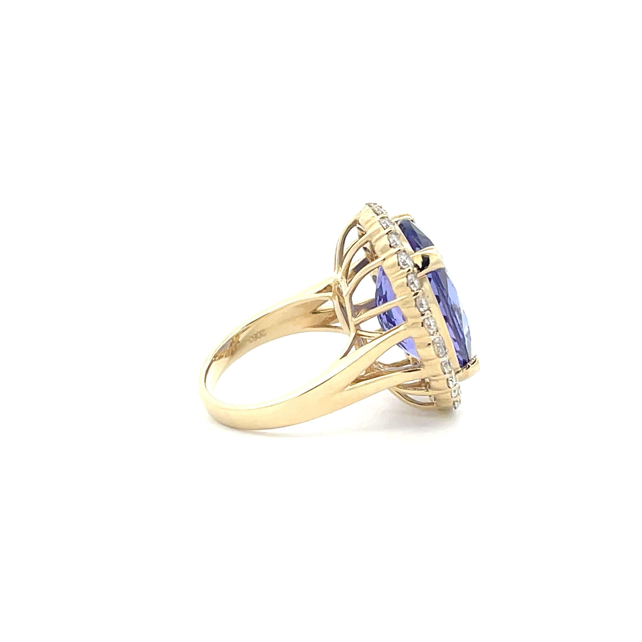 A striking cocktail ring featuring 16.46 cts. of fine, oval-cut tanzanite and 28 exquisite diamonds in a halo design prong set in 14K Yellow Gold. Handmade by professional artisans from start to finish, this exclusive heirloom piece is sure to make