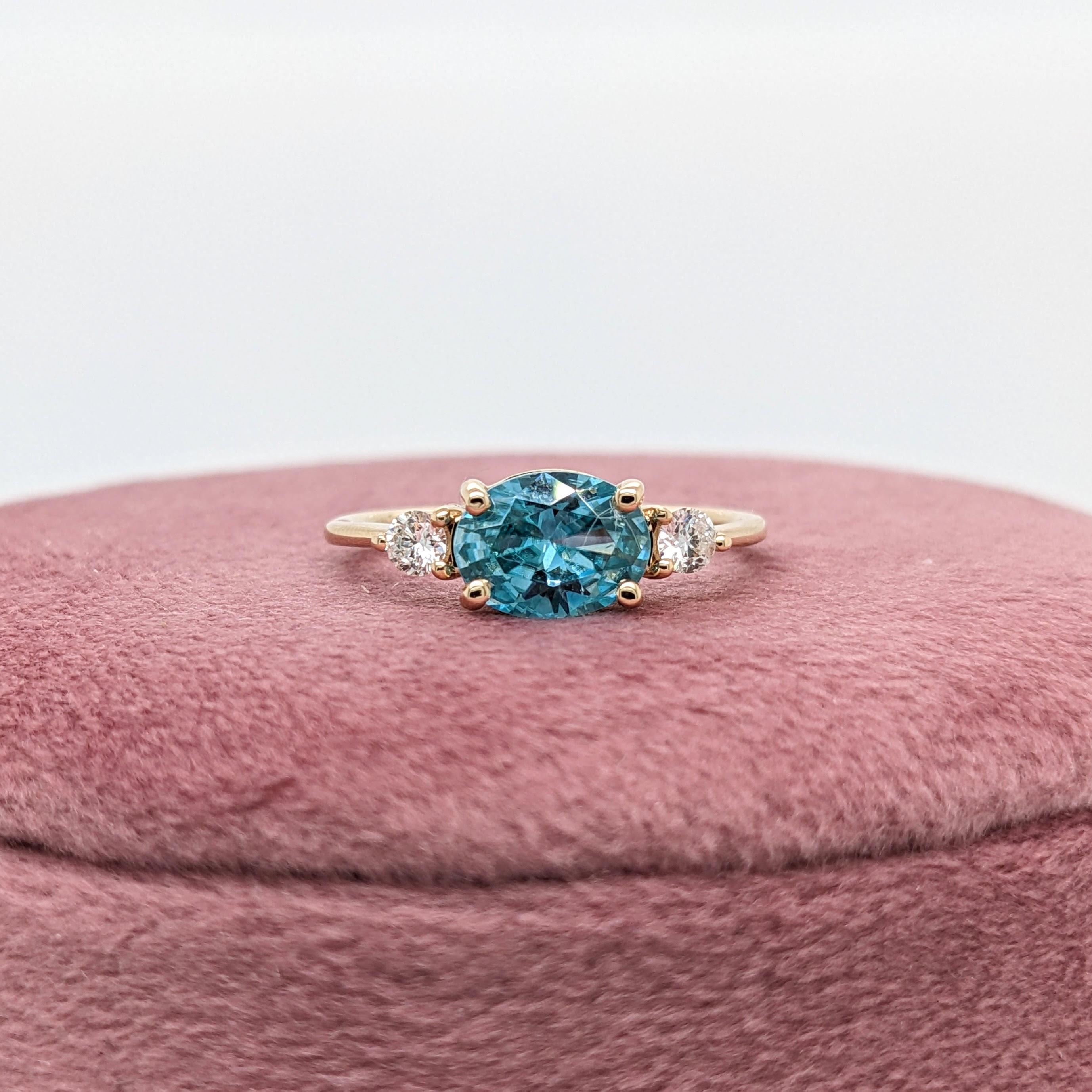This beautiful ring features a sparkling blue zircon in 14k yellow gold and two diamond accents. A dainty ring design perfect for an eye catching engagement or anniversary. This ring also makes a beautiful birthstone ring for your loved ones.

The