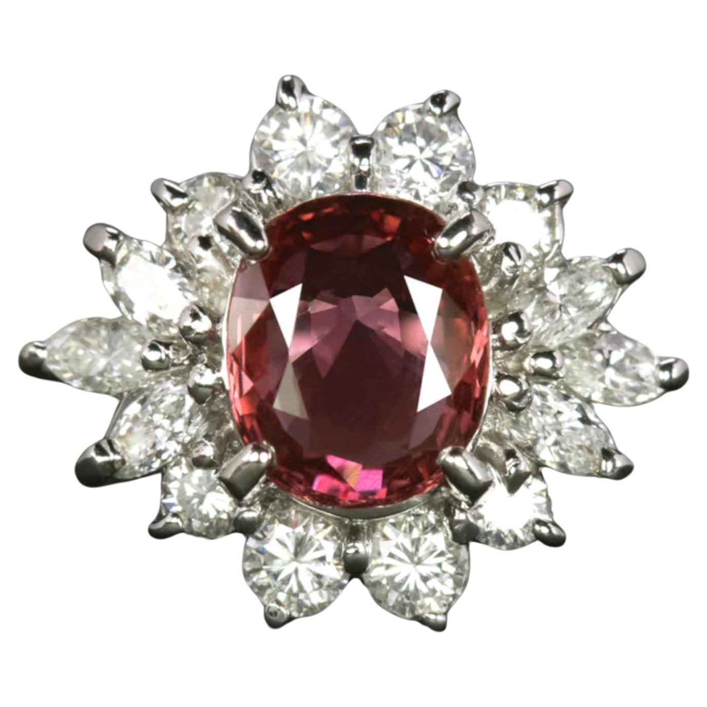 This elegant cocktail ring features a rich red ruby surrounded by a halo of round and marquise cut diamonds.

Highlights:

- 1.13ct natural ruby center with a bright red hue

- 0.51ct of very bright white and exceptionally clean G-H VS1 diamonds

-