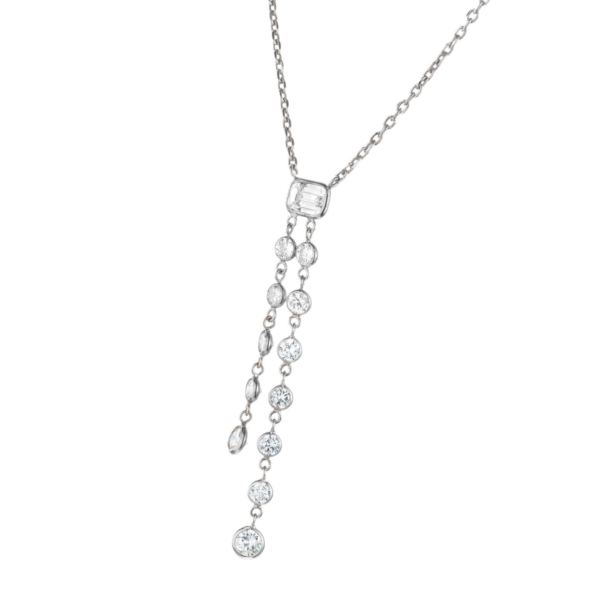 Round and Emerald cut diamond drop necklace. Emerald center stone with two dangle rows of round diamonds on a 18 inch cable chain in 14k white gold. 

12 round full cut diamonds, approx. total weight .95cts G, VS
1 Emerald cut diamonds, approx.