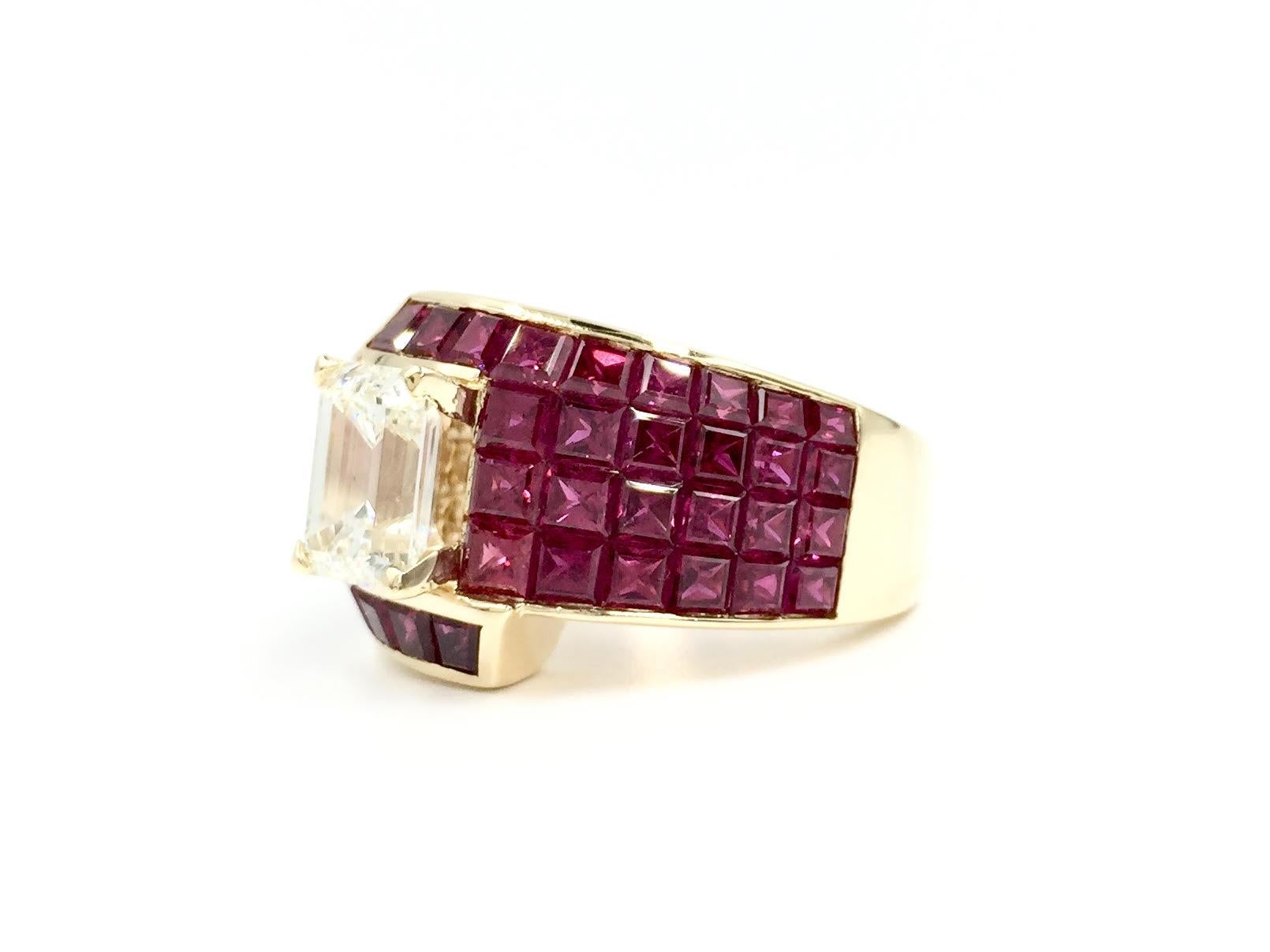 An absolute show-stopper featuring a beautiful 1.65 carat emerald cut diamond surrounded by 7.74 carats of gorgeous princess cut rubies. Vivid red rubies have a very slight purple/magenta hue found in the finest rubies which are expertly invisibly