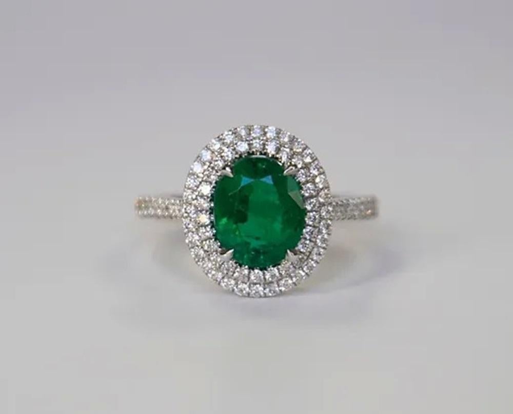 Emerald Weight: 1.65 ct, Measurements: 8.71 x 7.16 mm, Diamond Weight: 0.38 ct, Metal: 18K White Gold, Gold Weight: 4.41 gm, Ring Size: 6.5, Shape: Oval, Color: Vivid Green, Hardness: 7.5-8, Birthstone: May, Origin: Zambia