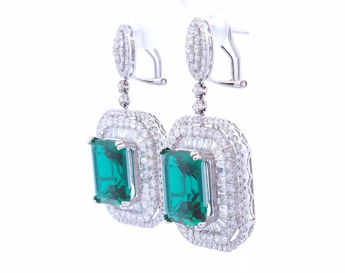 Quality, at the right price.

These designer dangling earrings feature a total carat weight 16.43 lab emeralds. These earrings also have a double halo design with 7.74 carats of round diamonds and 7.74 carats of baguette diamonds. This one of a kind