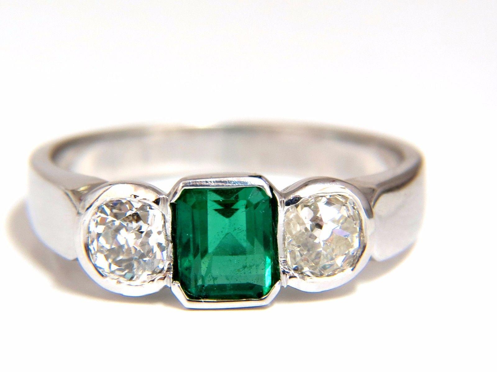 Mod Deco Green.

.88ct. Natural Emerald Ring

5 X 4.50mm

Full cut emerald brilliant 

Transparent & Top Vivid Green 

.77ct. Diamonds.

Round & full cuts 

G-color Vs-2 clarity.  

18kt. white gold

4.2 grams

Ring Current size: 7.5

Depth of ring:
