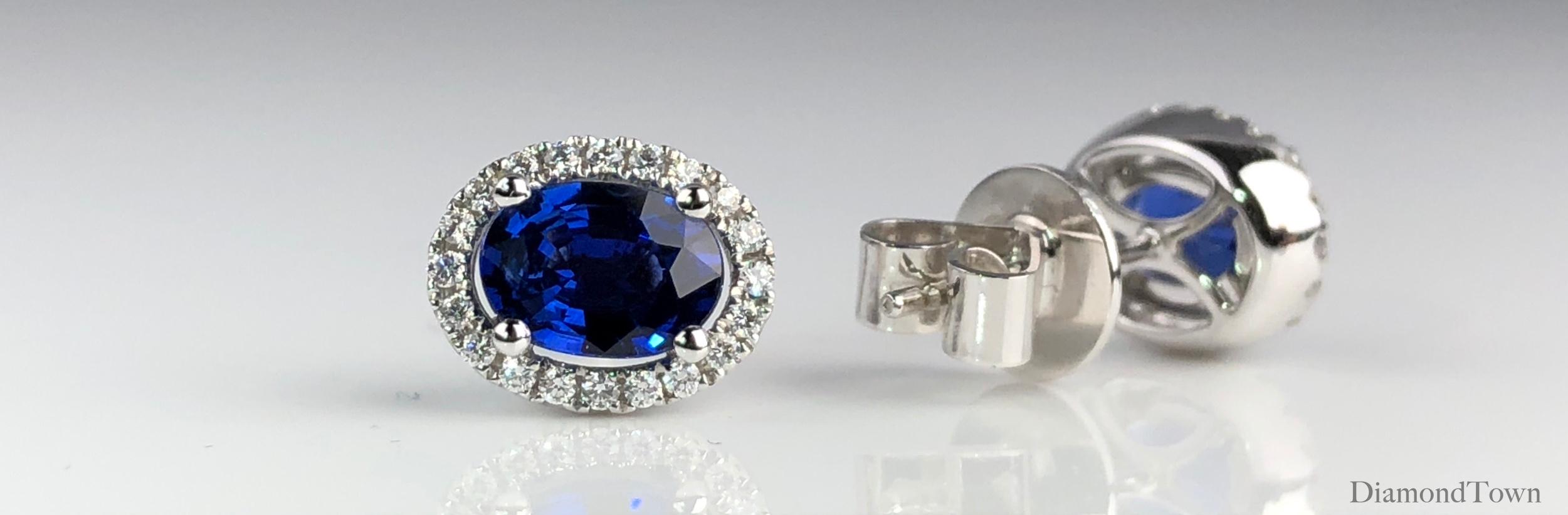 These lovely earrings feature an oval cut vivid blue sapphire (total weight 1.65 carats), surrounded by a a halo of round white diamonds (total weight 0.19 carats).

There is a seasonal promotion available on this piece.  For details please inquire