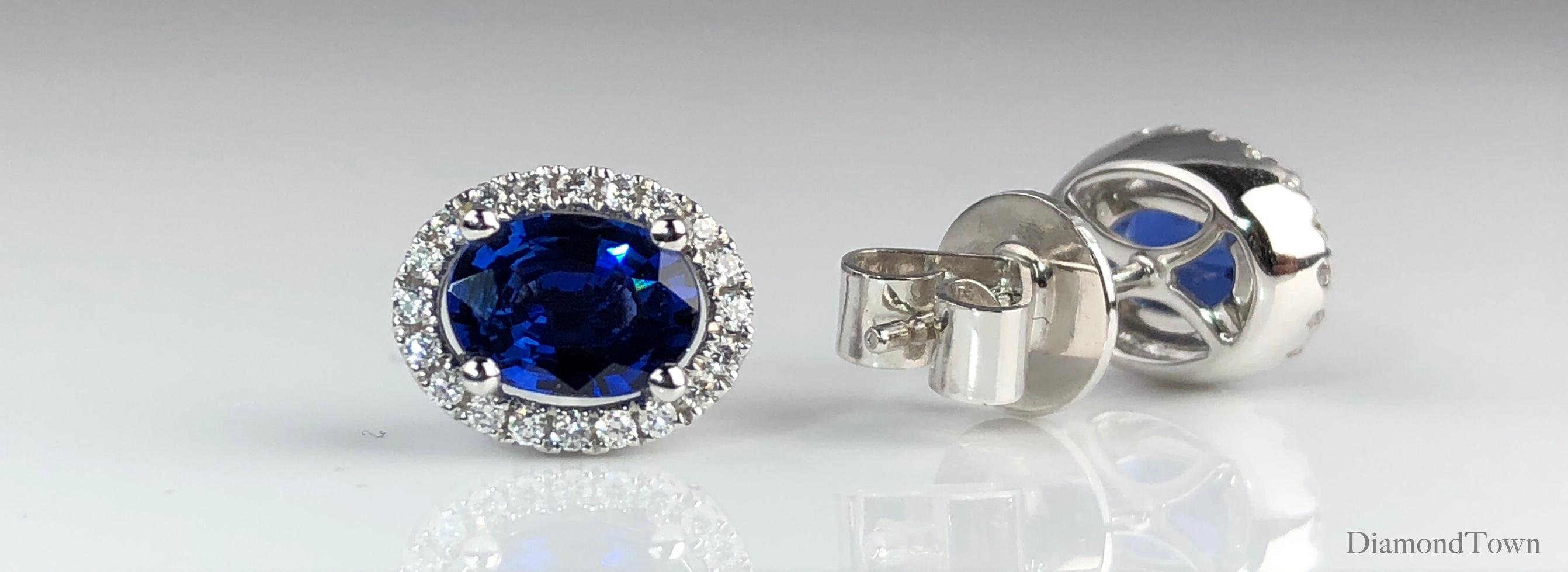 Contemporary 1.65 Carat Oval Cut Blue Sapphire Earrings with Diamond Halo in 18k White Gold