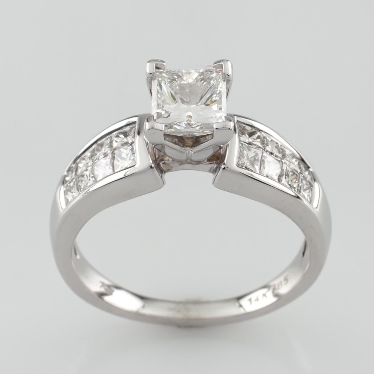Gorgeous Princess cut engagement ring with Princess cut accent stones
Ring Size 7
Total Mass = 5.3 grams
Center Stone Details:
Cut: Princess
Size: 1.0 Carats
Color: H
Clarity: SI2
Accent stones are princess cut (2 rows of 4 diamonds on each side of