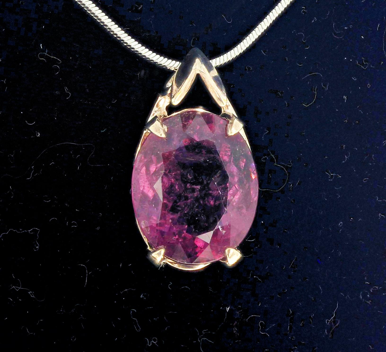 This glistening oval cut natural purpley-pinky 16.5 carat Tourmaline is set in a Sterling  Silver pendant. The Tourmaline gemstone is 18 mm x 15 mm.   (The chain is not included).