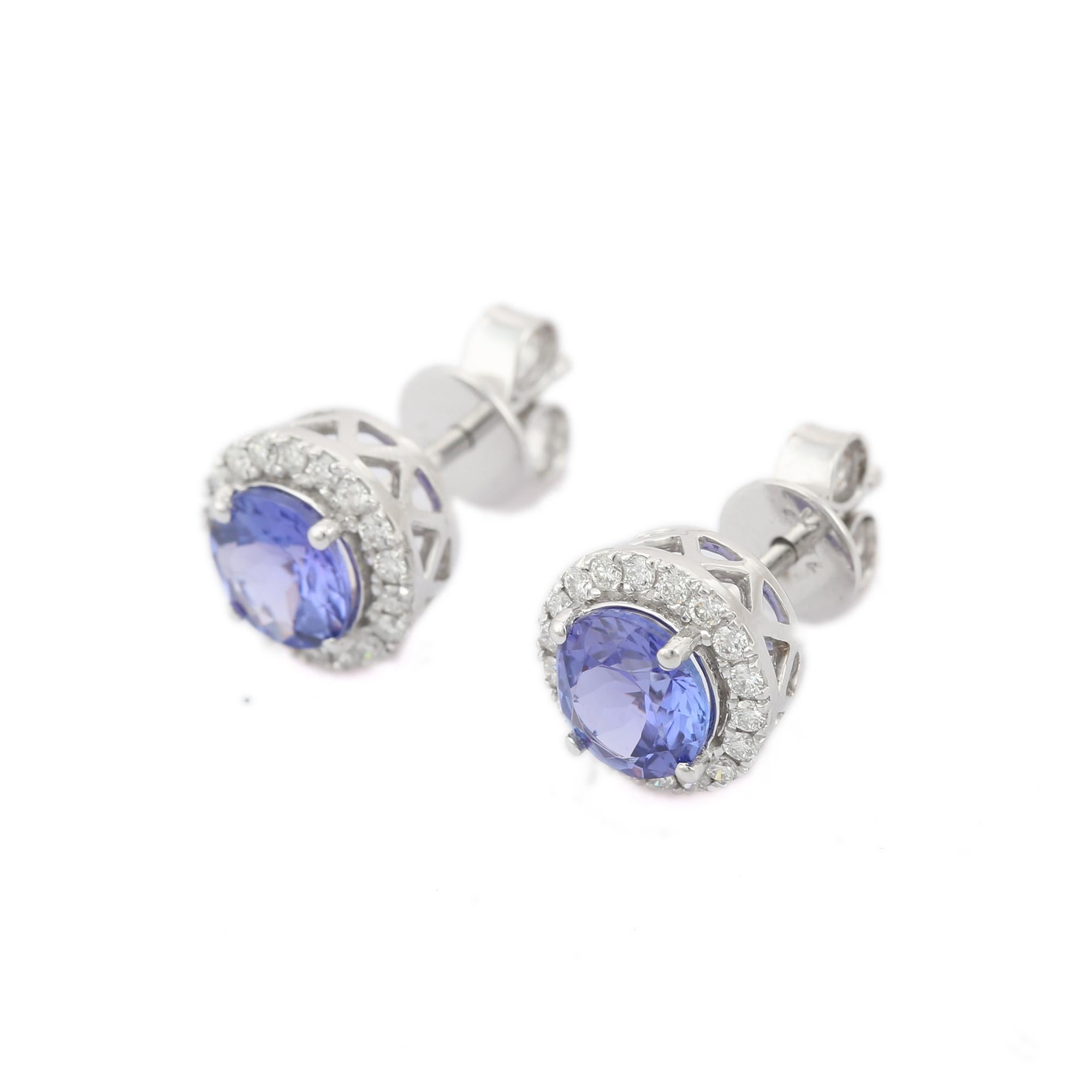 Studs create a subtle beauty while showcasing the colors of the natural precious gemstones and illuminating diamonds making a statement.

Round cut tanzanite studs with diamonds in 18K gold. Embrace your look with these stunning pair of earrings