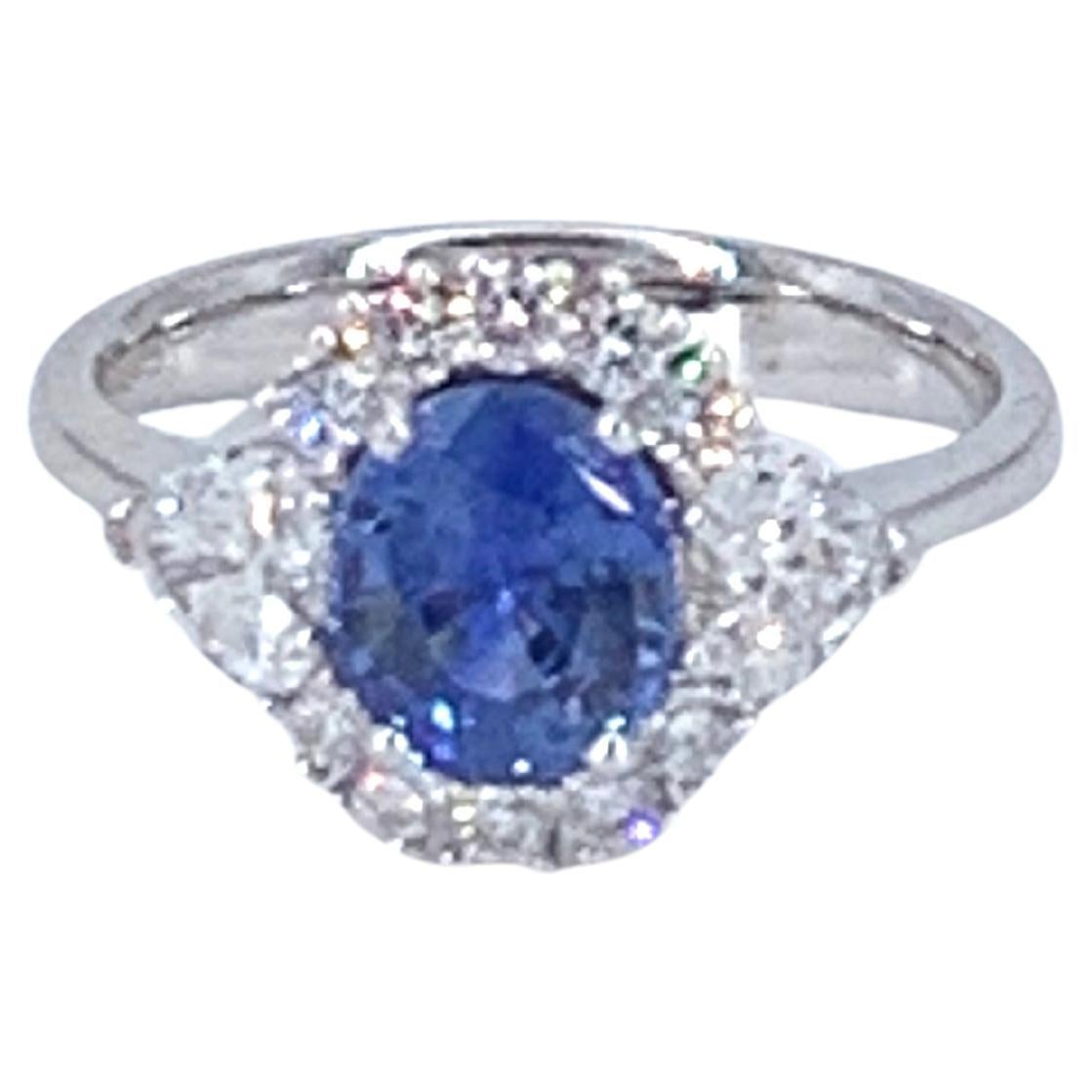 This beautiful 1.65 Carat Sapphire sits within 1.23 Carats of natural Diamond and is all set in 18kt white Gold. 

Unlike the average Sapphire ring with Diamond around, this design adds flare and extra beauty by having 2 pear shaped Diamonds on