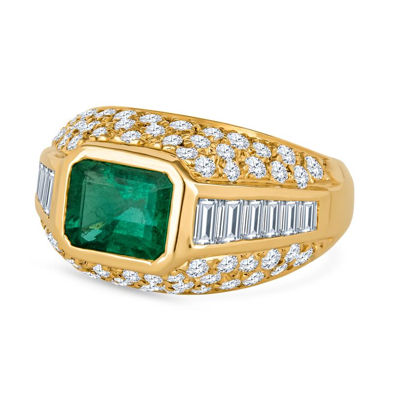 A lovely 1.65 Carat Zambian Emerald Cut Emerald Ring bezel set in18 Karat yellow gold featuring 6 graduating natural diamond baguettes on either side the ring and 68 round brilliant diamond embedded along the opposing two sides, For those who are