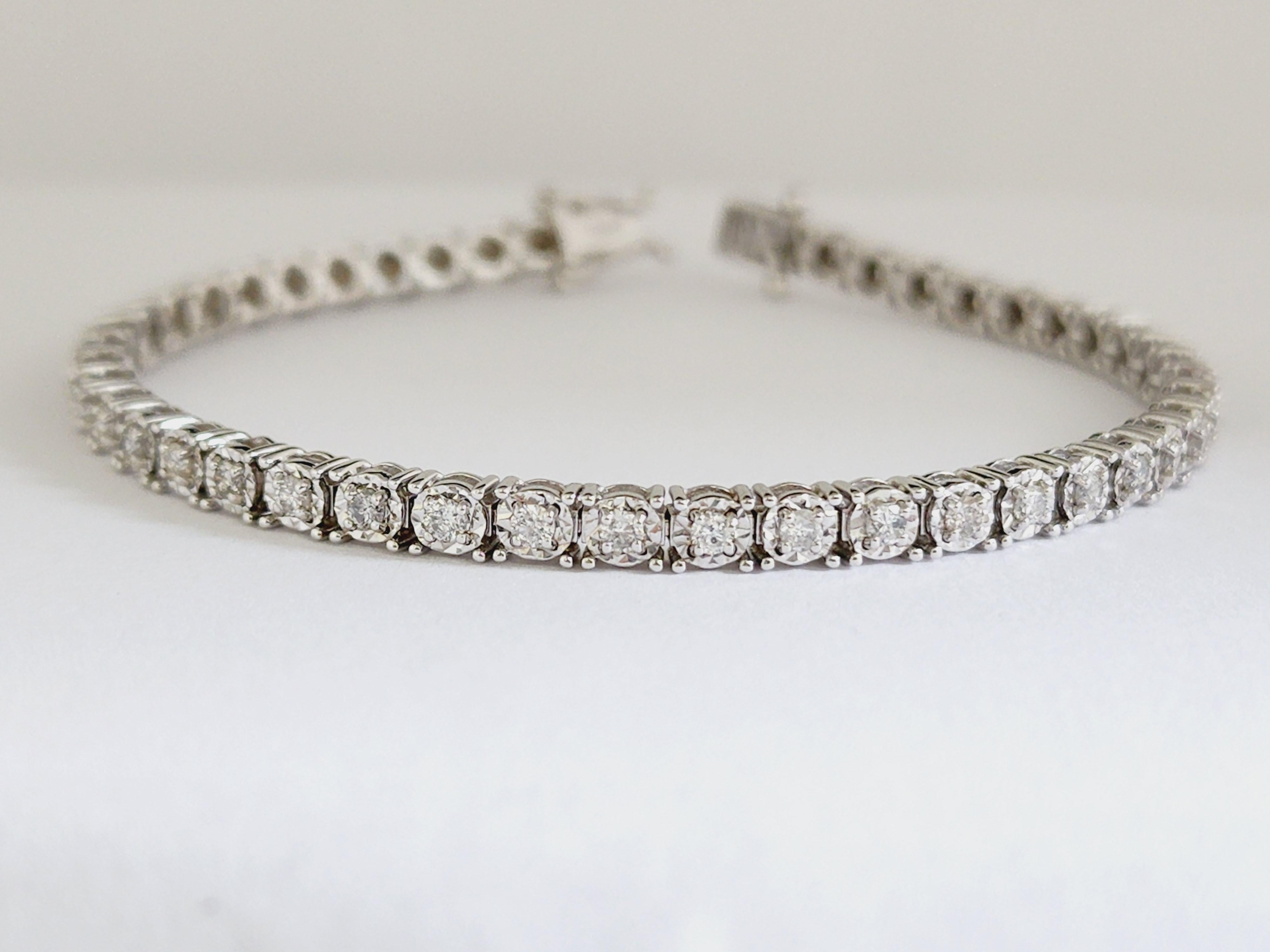 1.69 Carats Diamond Cut Miracle Set Tennis Bracelet 14 Karat White Gold
Natural Diamonds Approx. 1.65 carat total weight
Average Display Color: I, Clarity: SI
Metal Type: 4 Prong 14 karat yellow gold miracle setting
Length 7 inch 