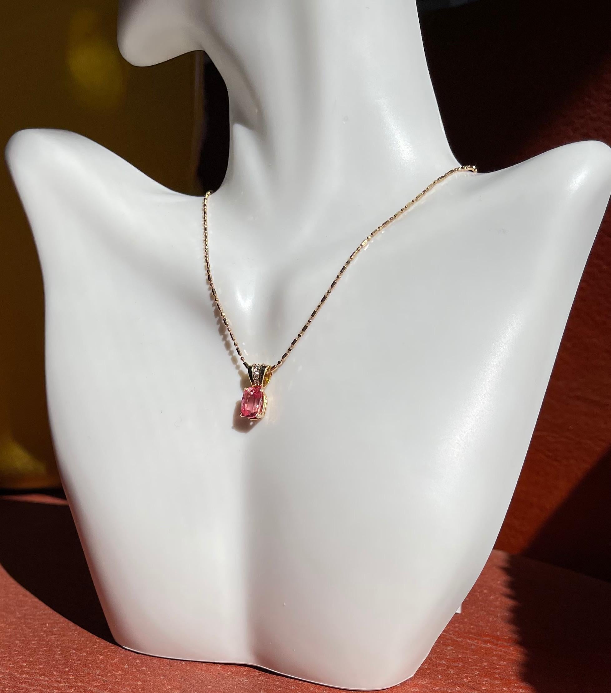 Colorado is known for having one of the finest gem grade Rhodochrosite mines and is the location of this faceted 1.65 carats oval stone. We set this unusually clean stone in a 14-karat yellow gold pendant. The bale of the pendant is accented with 4