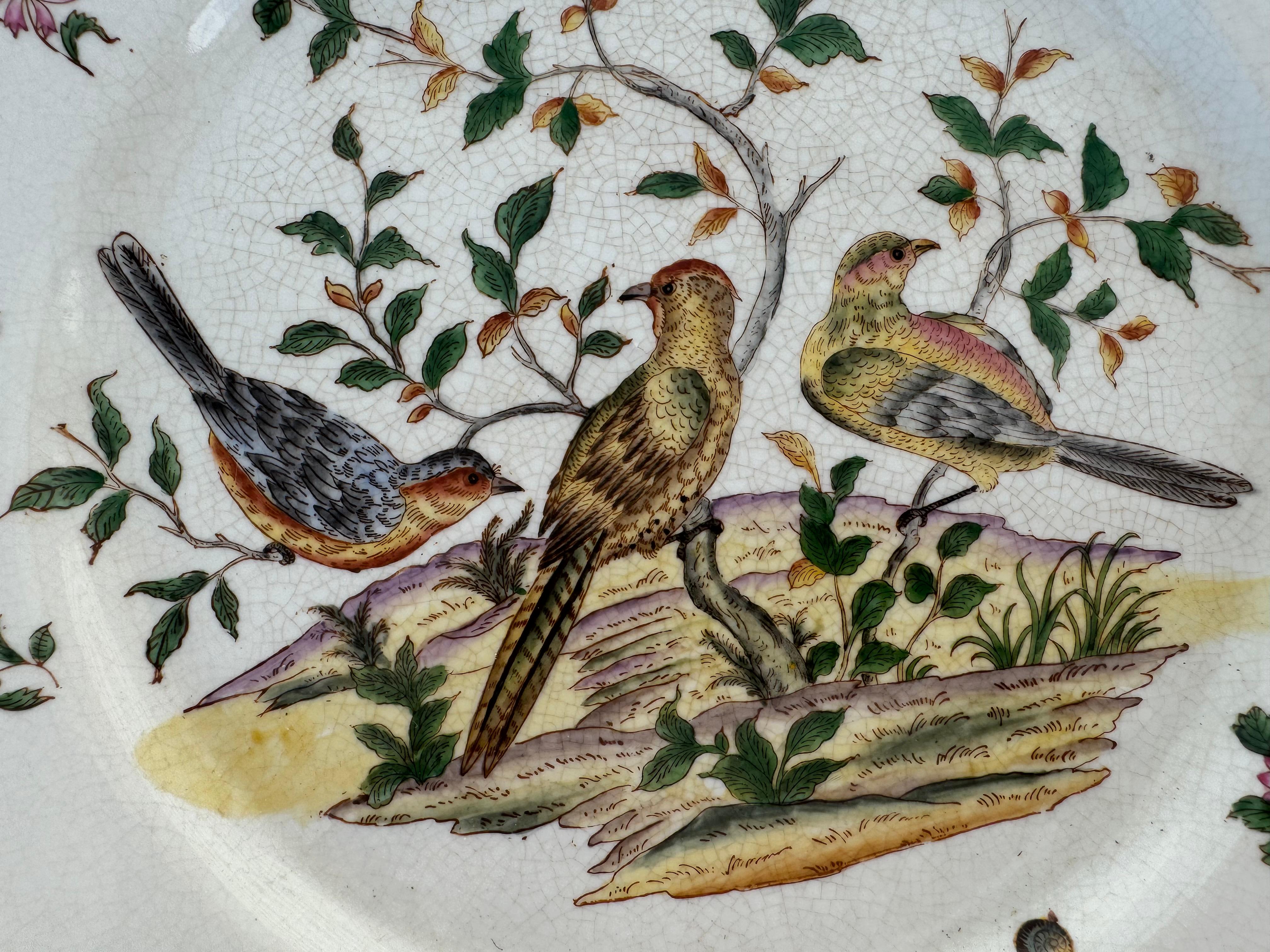 this Is a large size charger. I t was made in China in the later half of the 20th century. It depicts a scene of of 3 perching birds. the backgrou8nd has a nice patina crackling. The charger is trimmed in 14k yellow gold.

The bottom bears the
