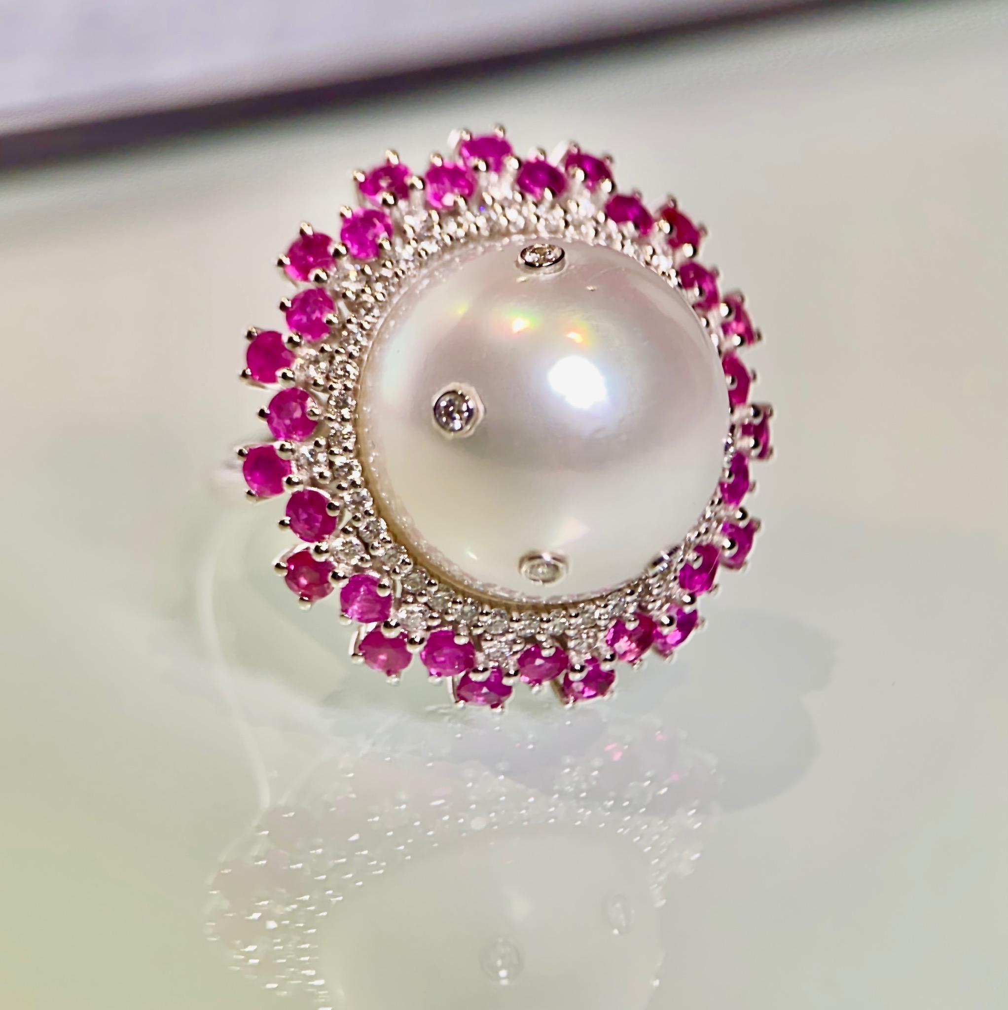 This ring comes with a massive 16.5mm White Australian South Sea Pearl. We were experimenting with adding diamonds on the surface of the pearl in order to add  sparkle and fire to the pearl and this is the end result. The Pearl is then surrounded by