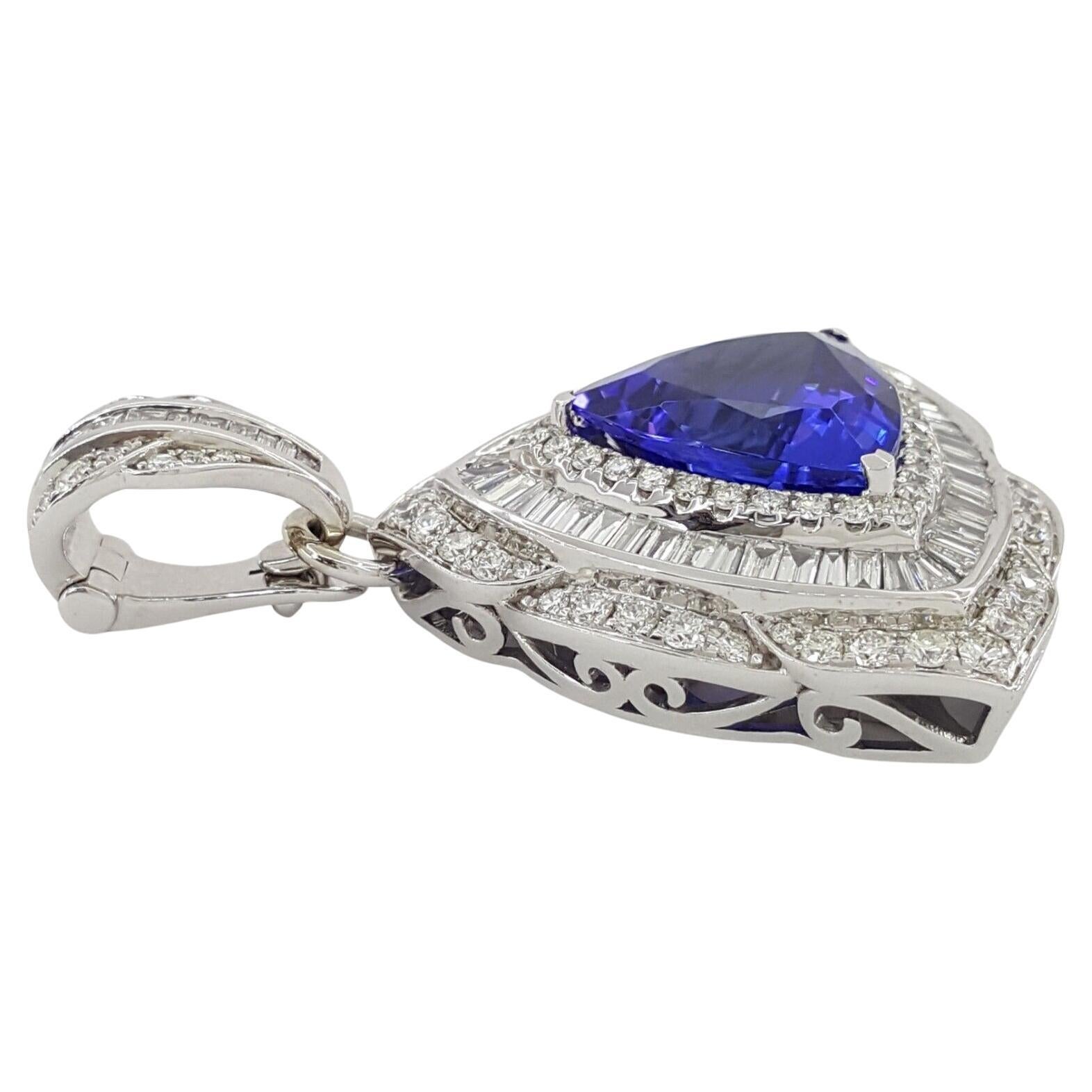 Behold the exquisite allure of the 16.52 ct Total Weight Trillion Cut Tanzanite Pendant, adorned with a mesmerizing halo of Round and Baguette Cut Diamonds, all set in 14K White Gold. This resplendent piece is a harmonious fusion of sophistication,